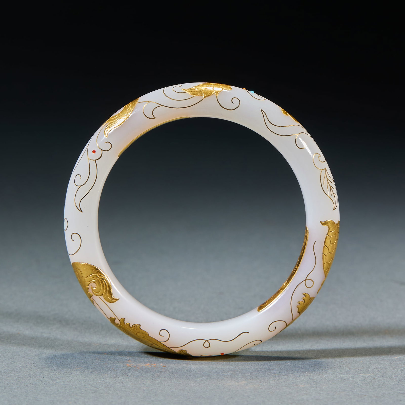 Gold Inlaid Jade Bangle: Gold-Inlaid Jade Bracelet: Made of Hetian jade with exterior gold-inlaid dragon patterns dotted with red gemstones, mild jade texture and exquisite craft; Inner diameter 5.8cm, weight 60g; A noble anc
