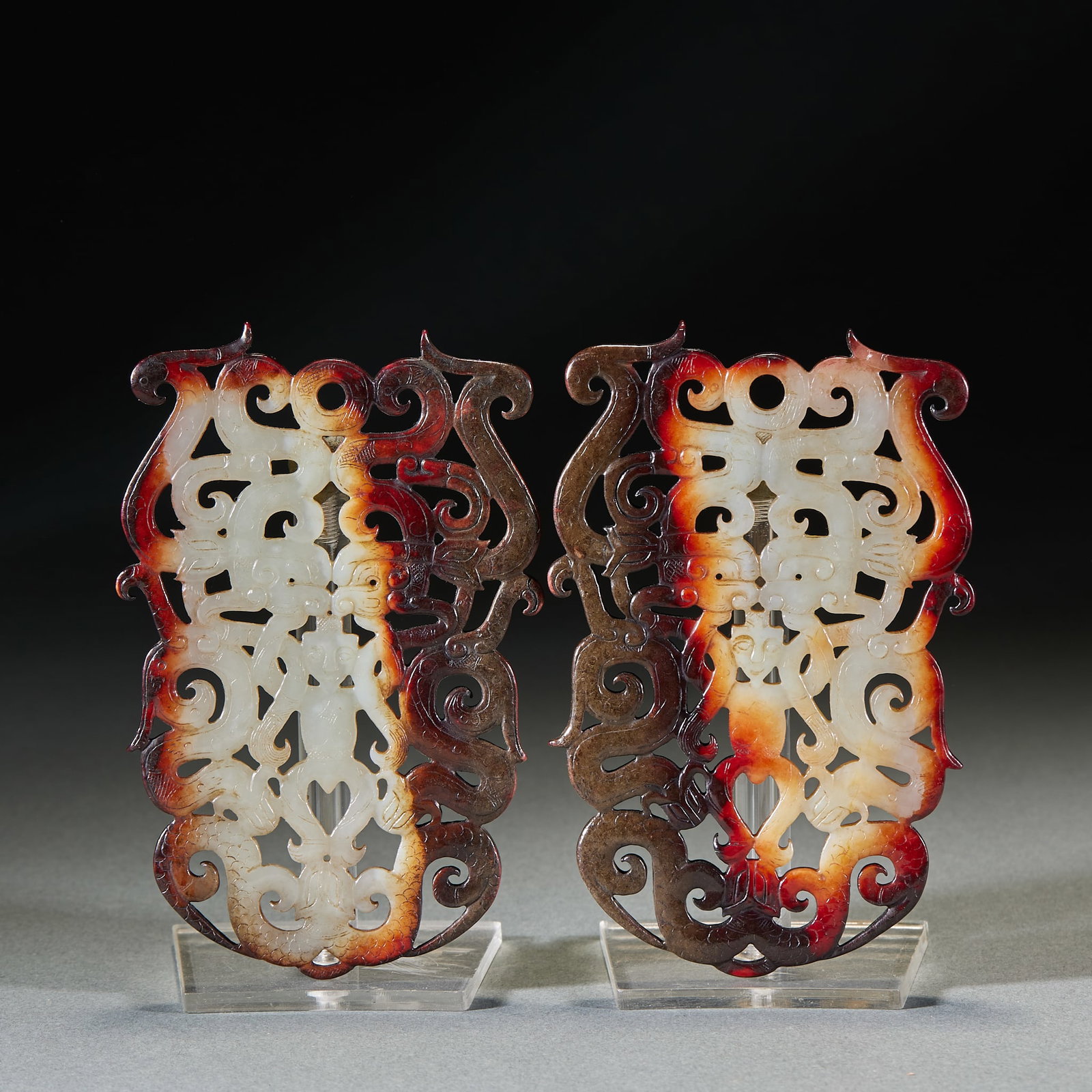 Han Dynasty Dragon Pattern Jade Bi Disc, A Pair: Pair of Han Dynasty Dragon Pattern Jade Bi: Made of Hetian jade with red natural mottling, openwork carved with dragon patterns, preserved as an intact pair; Length 11.5cm, width 7.5cm; Classic Han Dy