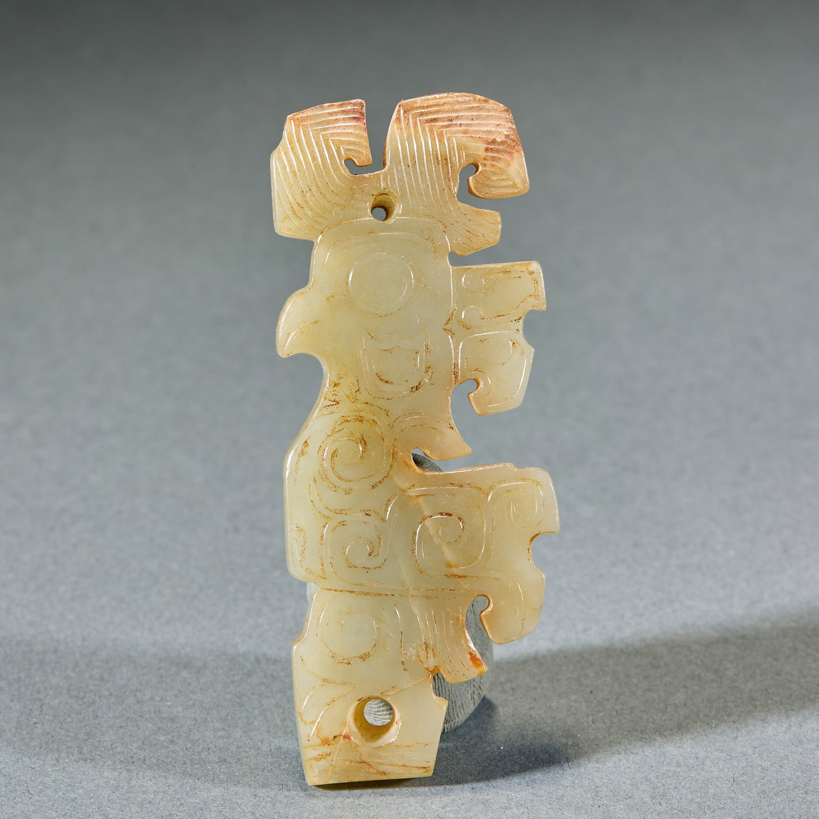 Shang and Zhou Divine Bird Jade Pendant: Shang and Zhou Divine Bird Jade Pendant: Made of Hetian jade with natural mottling, carved into divine bird shape with simple primitive lines; Length 8cm, width 3.2cm, weight 29g; A typical pendant of