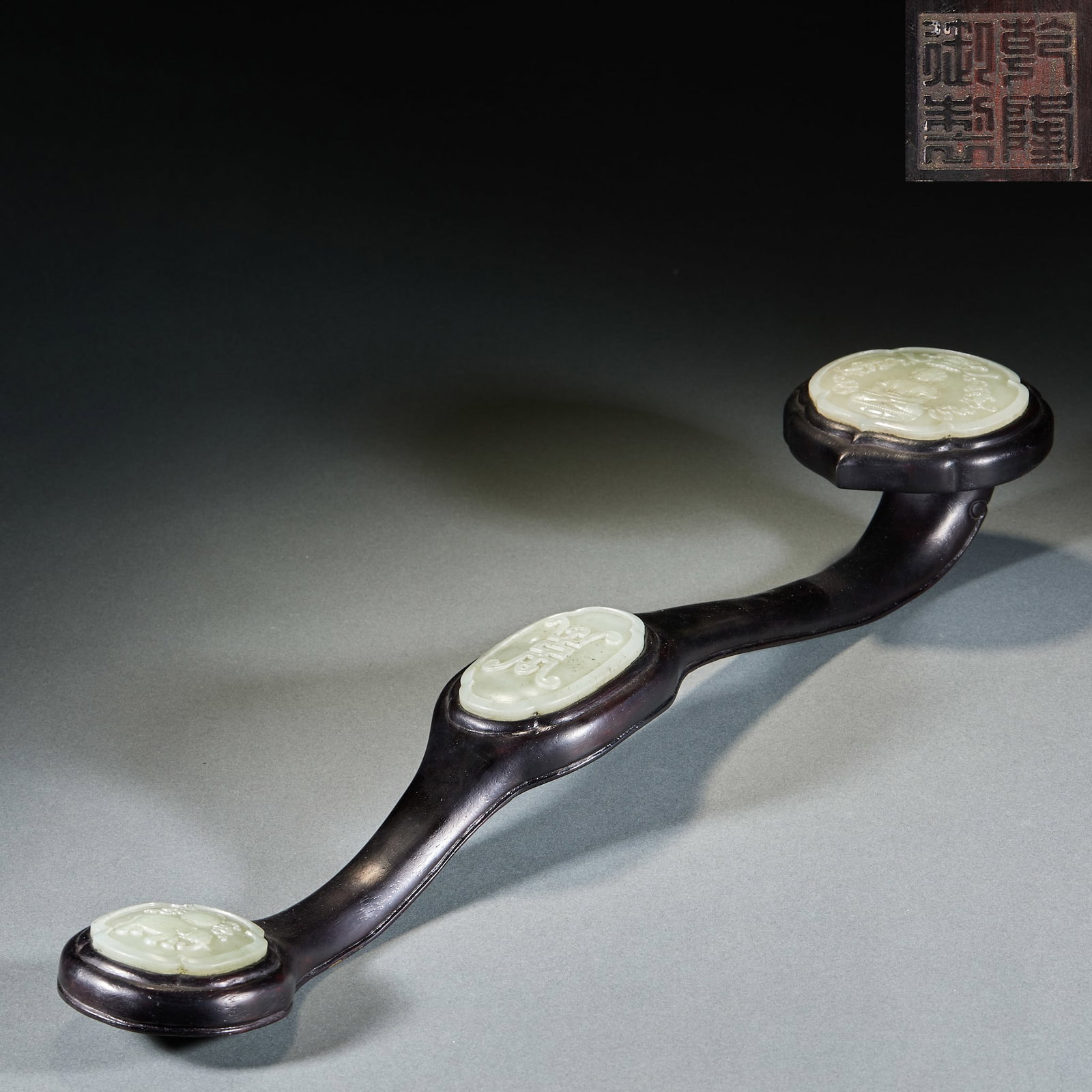 Qianlong Mark Red Sandalwood Jade Inscribed Ruyi Scepter: Qianlong Sandalwood Jade-Inlaid Poem Ruyi: Sandalwood handle inlaid with Hetian jade ornaments carved with poems and patterns; Height 8cm, length 56cm, width 10cm; A royal court artifact of the Qing D