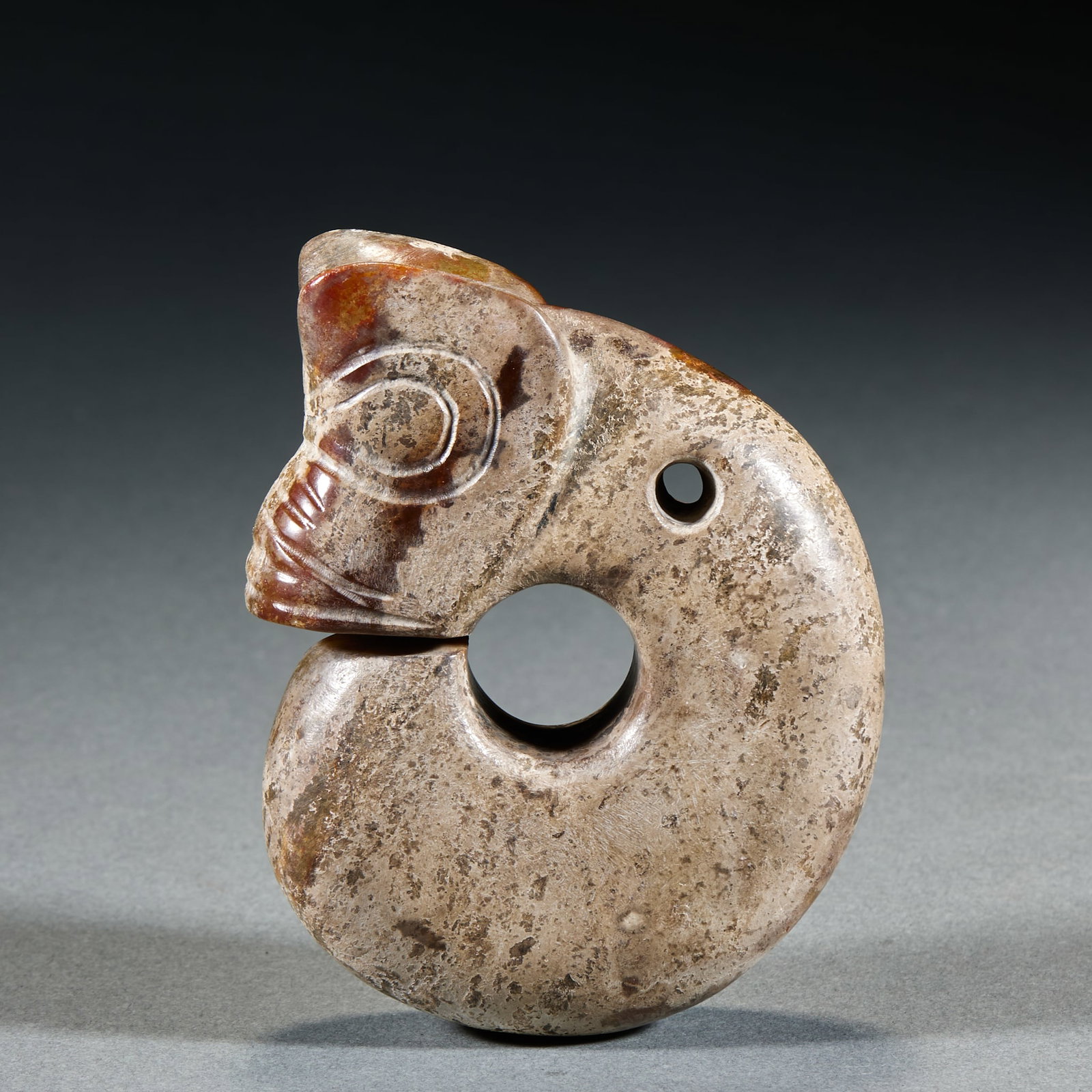 Hongshan Culture C-Shaped Dragon: Hongshan Culture C-Shaped Dragon: Made of Hetian jade with natural mottling, carved into classic C-shaped dragon form with simple primitive lines; Height 10.3cm, length 8cm, thickness 2.8cm, weight 39