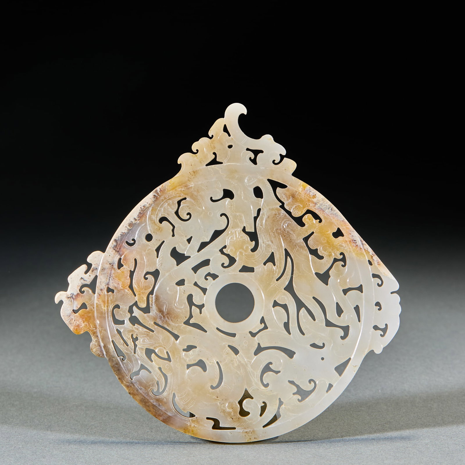 Han Dynasty Protruding Dragon and Phoenix Jade Bi Disc: Han Dynasty Outlined Dragon and Phoenix Pattern Jade Bi: Made of Hetian jade with natural mottling, outlined carved with complicated dragon and phoenix patterns; Length 12.7cm, width 12.5cm, weight 94