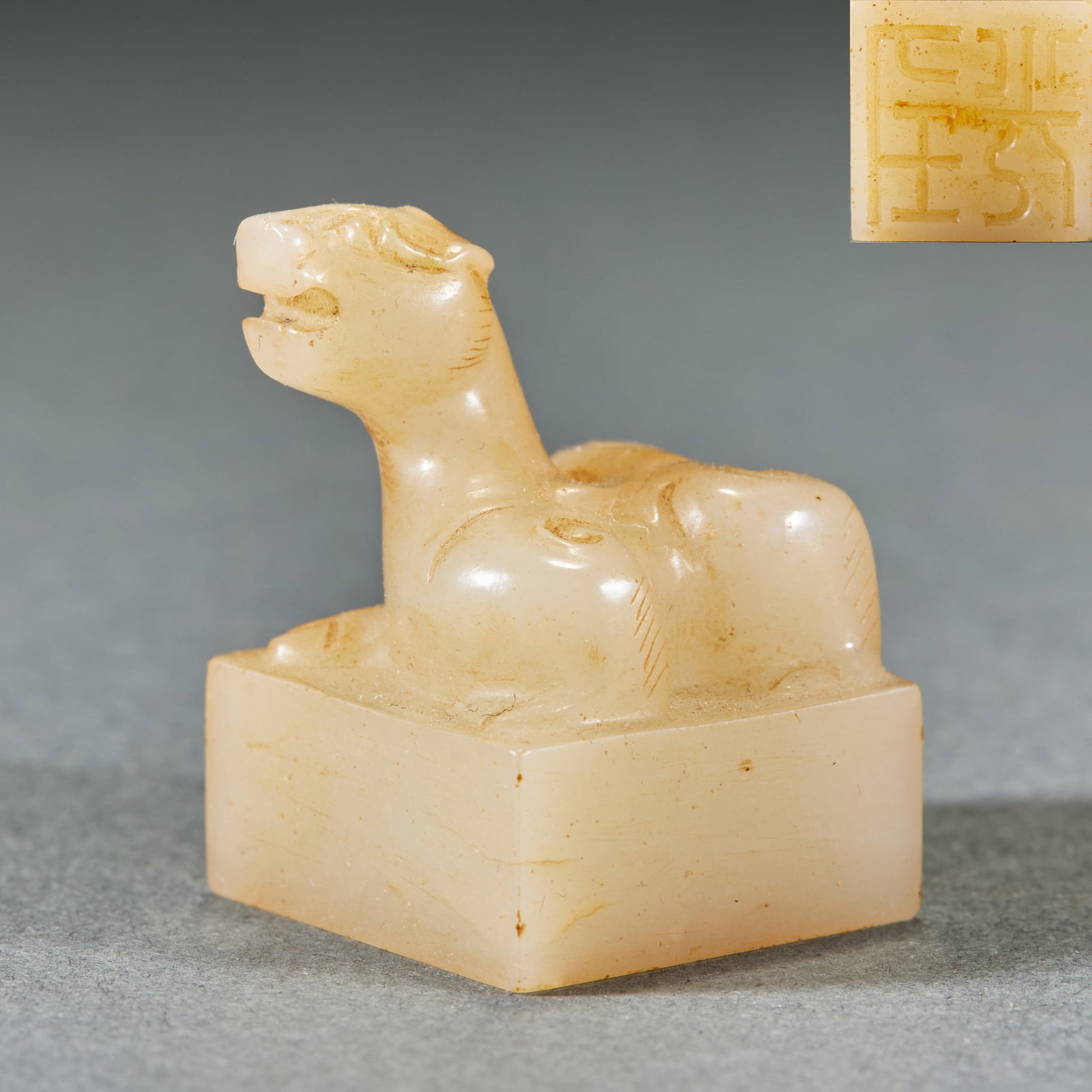 Han Dynasty Beast Button Jade Seal: Han Dynasty Beast Button Jade Seal: Made of Hetian jade with natural mottling, seal knob carved with mythical beast and carved characters on the seal face; Height 2.8cm, length 2cm, width 2cm, weight 
