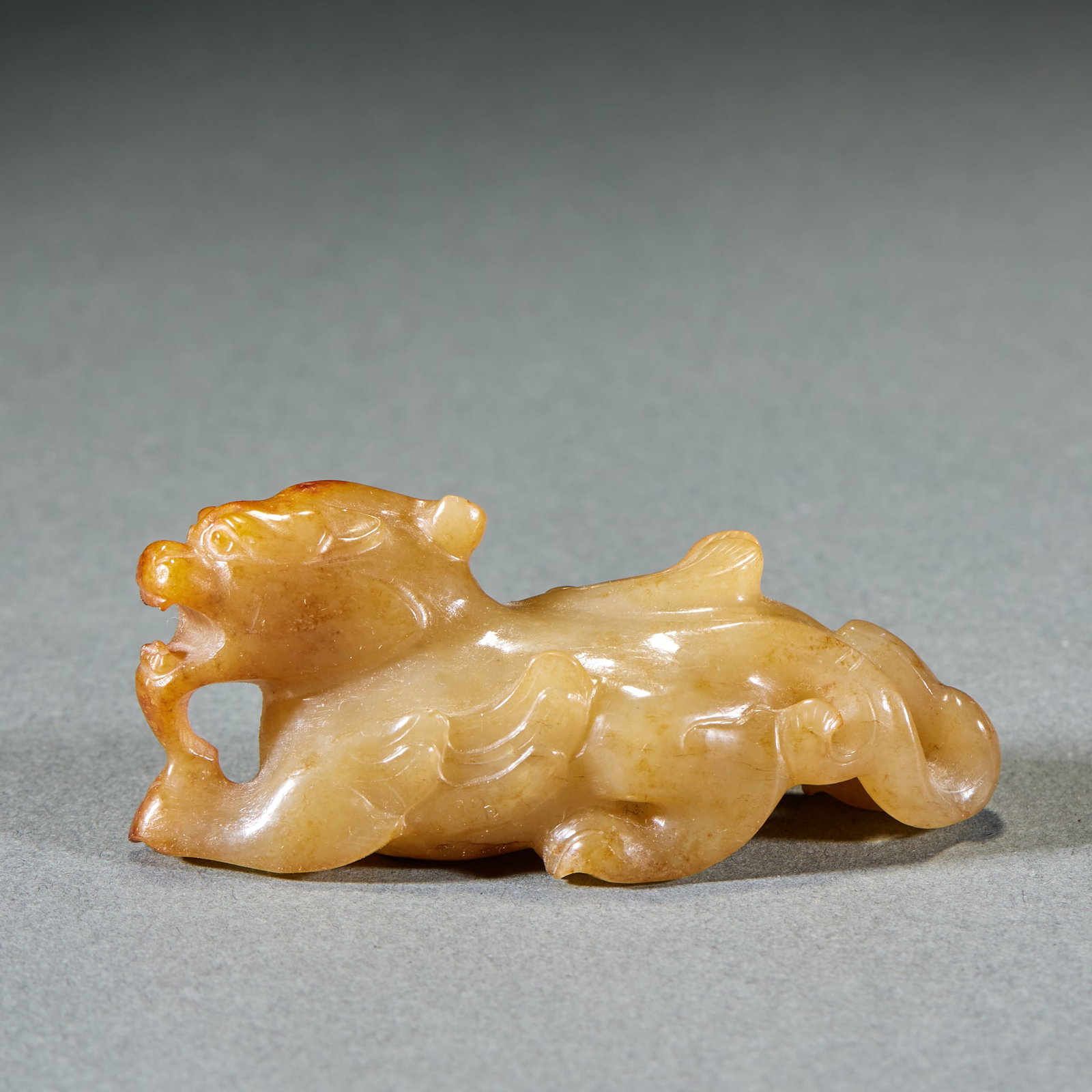 Warring States to Han Auspicious Beast Seal: Warring States and Han Dynasty Mythical Beast Jade Ornament: Made of Hetian jade with yellow natural mottling, carved with mythical beast shape and concise lines; Height 3cm, length 7.2cm, width