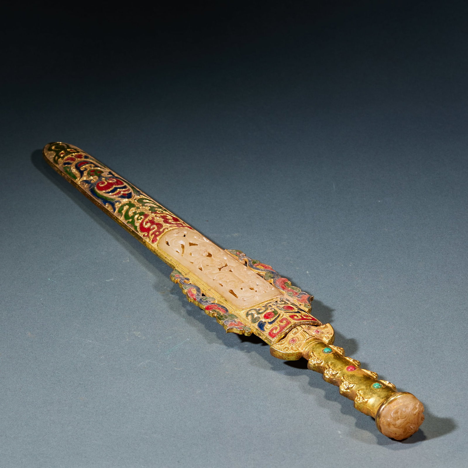 Gilt Painted Jade Inlaid Bronze Sword: Gilt Painted Jade-Inlaid Bronze Sword: Bronze sword body decorated with gilt painted patterns, the scabbard inlaid with jade ornaments adopting luxurious craft; Length 48cm, width 7cm; An ancient