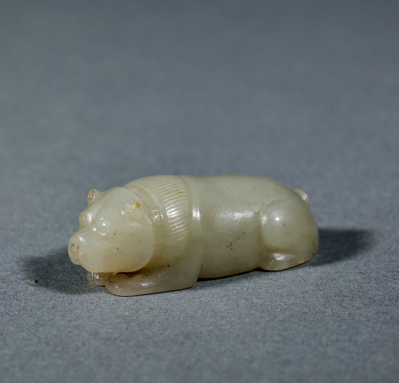 Hetian Jade Bear: Hetian Jade Bear: Made of Hetian jade round carved into reclining bear shape with simple naive posture and fluent lines; Height 1.7cm, length 4.7cm, width 2.2cm, weight 29g; Featuring fine oily jade