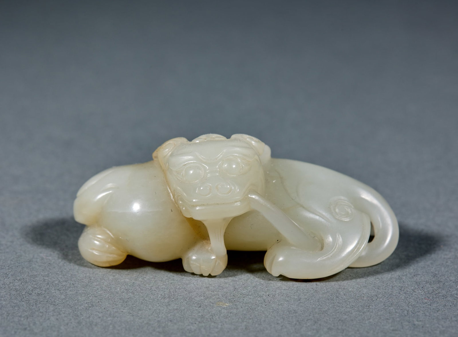 Hetian Jade Auspicious Beast: Hetian Jade Mythical Beast: Made of Hetian jade round carved into powerful mythical beast shape with dignified posture; Height 2.9cm, length 6.8cm, width 4cm, weight 93g; Boasting mild jade texture