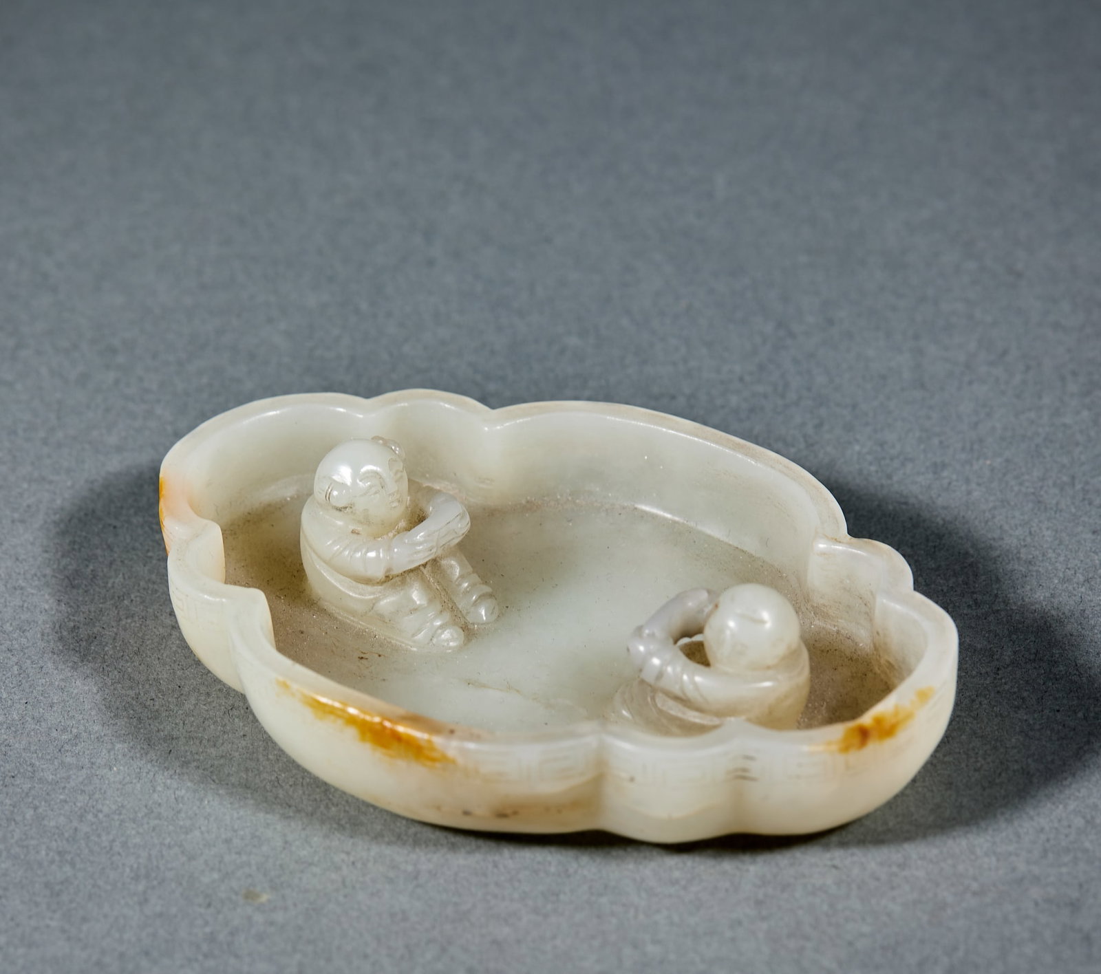 Hetian Jade Brush Washer: Hetian Jade Brush Washer: Made of white Hetian jade carved with boy patterns and mild jade texture; Height 2.1cm, length 9.1cm, width 6.4cm, weight 82g; Compact elegant shape and delicate carving