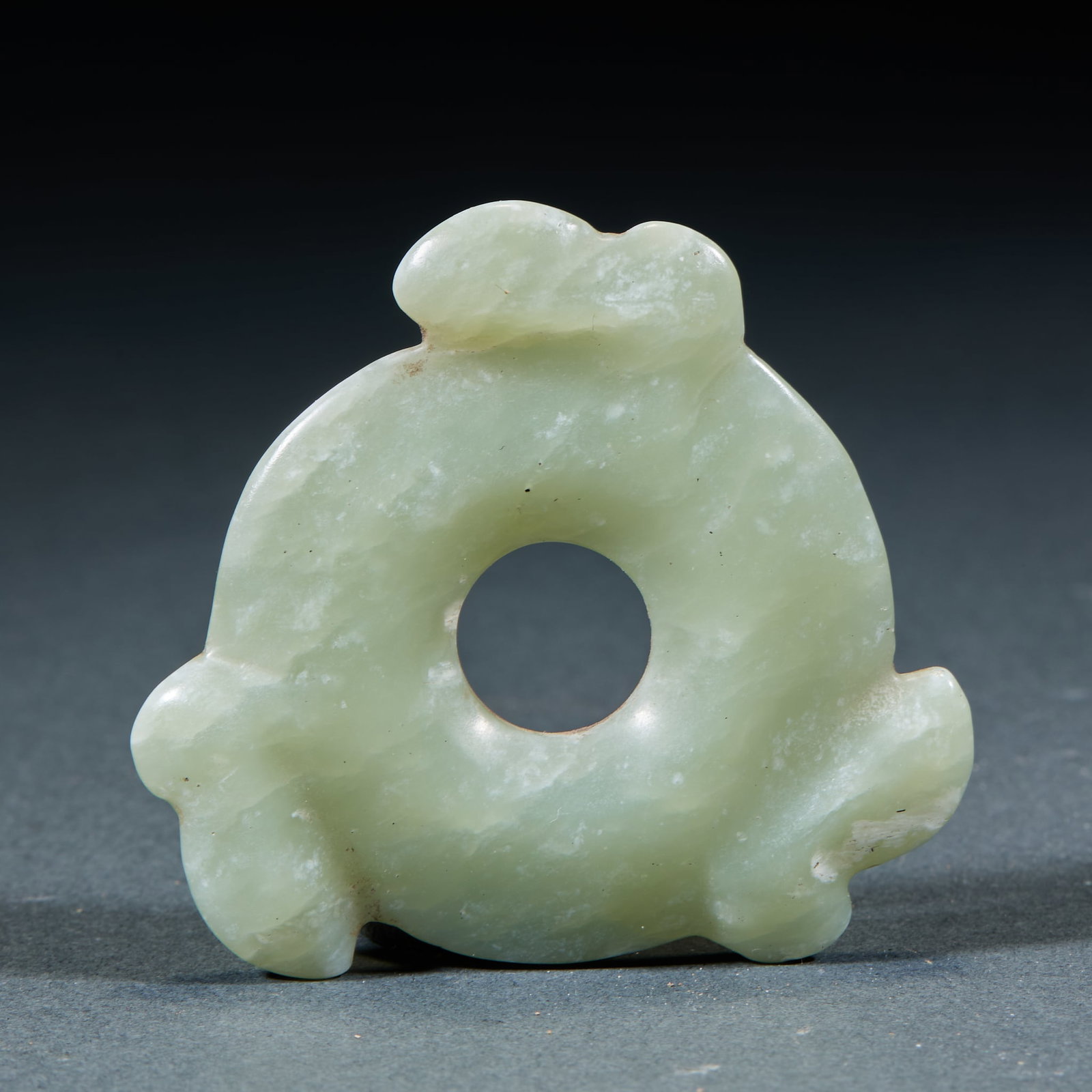 Hongshan Jade Disc Ornament: Hongshan Jade Xuanji: Made of blue-yellow jade with three-tooth shape, serving as an important ritual vessel of Hongshan Culture; Diameter 5.3cm; Regular shape and primitive craft make it a crucial