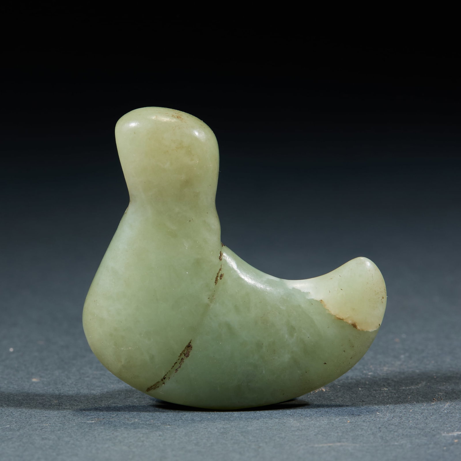 Hongshan Jade Beast Claw: Hongshan Culture Jade Beast Claw: Made of blue-yellow jade carved into beast claw shape with mild texture; Length 4.5cm, width 4cm; Concise craft and distinct Hongshan cultural characteristics mark it