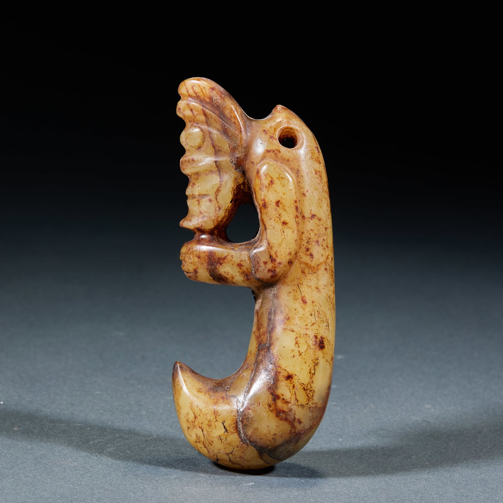 Hongshan Culture Hand-Holding Dragon: Hongshan Culture Hand-Clasping Dragon: Made of blue-yellow jade carved into unique hand-clasping dragon shape with primitive fluent lines; Length 10cm, width 3.5cm; Distinctive modeling and mild jade 