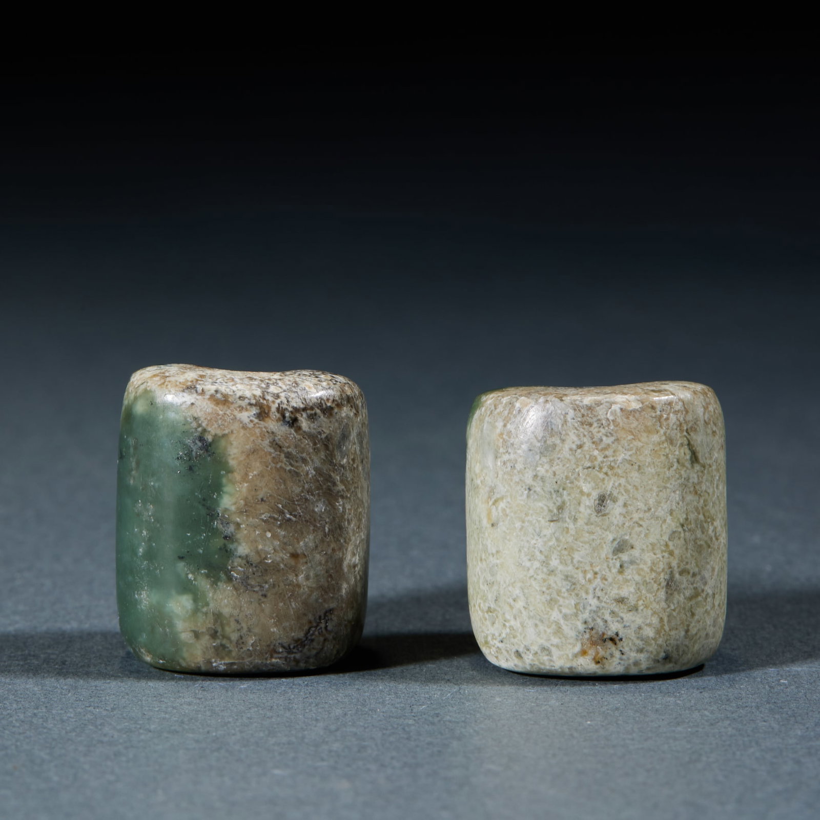 Hongshan Jade Lezi, A Pair: Pair of Hongshan Culture Jade Lezi: Made of jade with natural mottling, cylindrical Lezi preserved as an intact pair; Length 2.5cm, width 2.1cm; Classic Hongshan Culture jade pendants with practical s