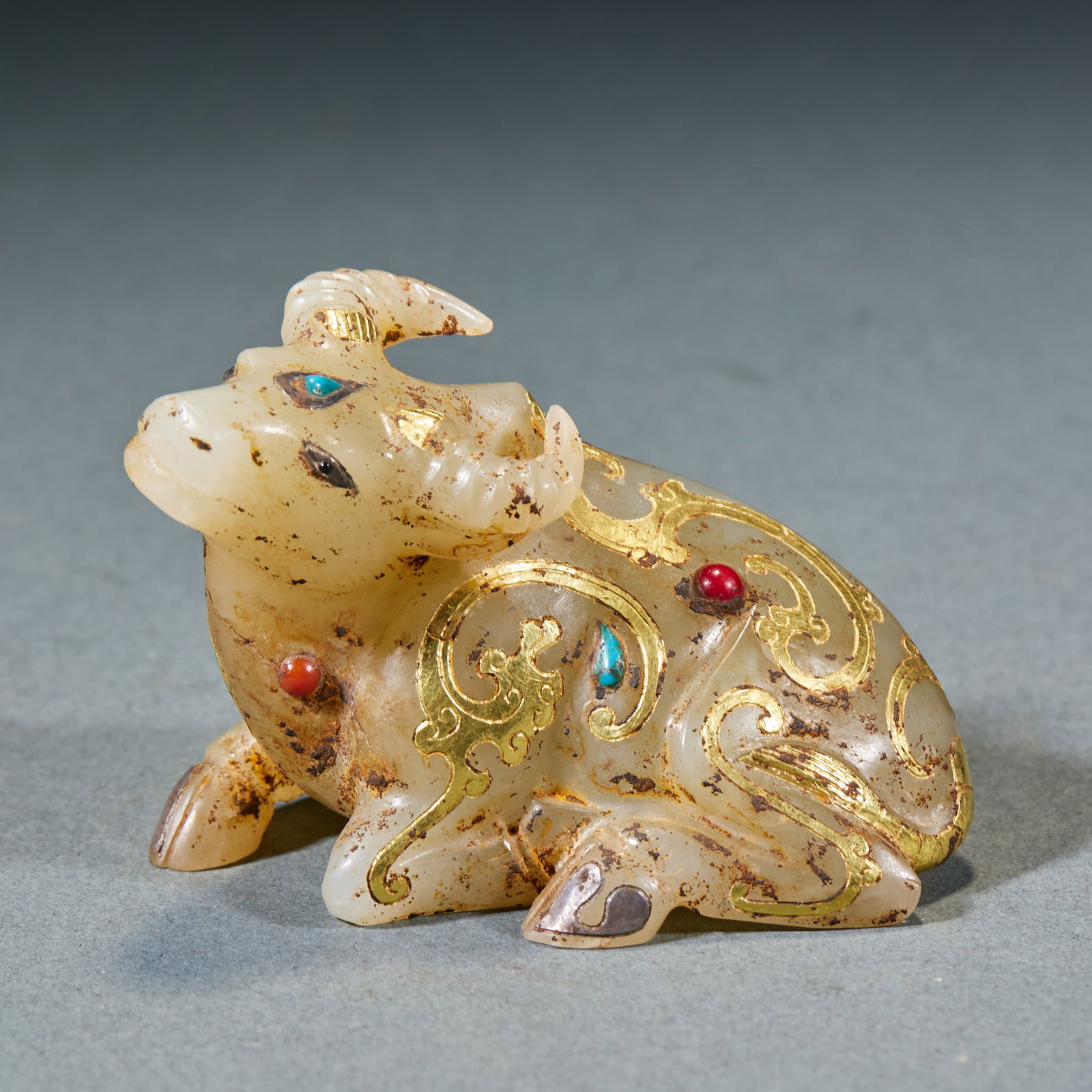 Gold Inlaid Jade Ox: Gold-Inlaid Jade Ox: Made of jade decorated with gold inlay and gemstone patterns, designed in realistic ox shape; Height 4.5cm, length 6.5cm, width 4.2cm, weight 125g; A classic ancient jade