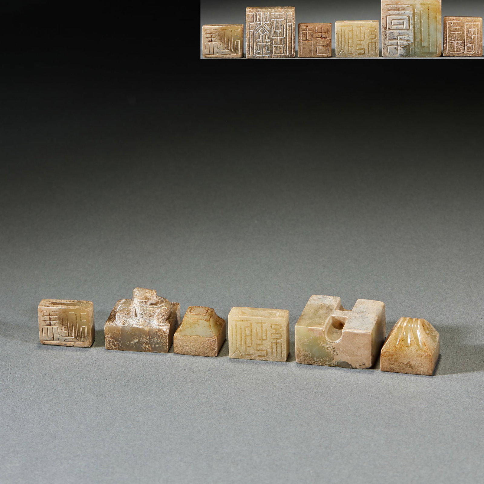 Pre-Ming Archaic Jade Seal Set, Six Pieces: Set of Pre-Ming High Ancient Jade Seals: Made of jade with natural mottling, primitive seal characters and diverse shapes, complete with six pieces in one set; Height 1.7cm, length 3.2cm; A set of anc