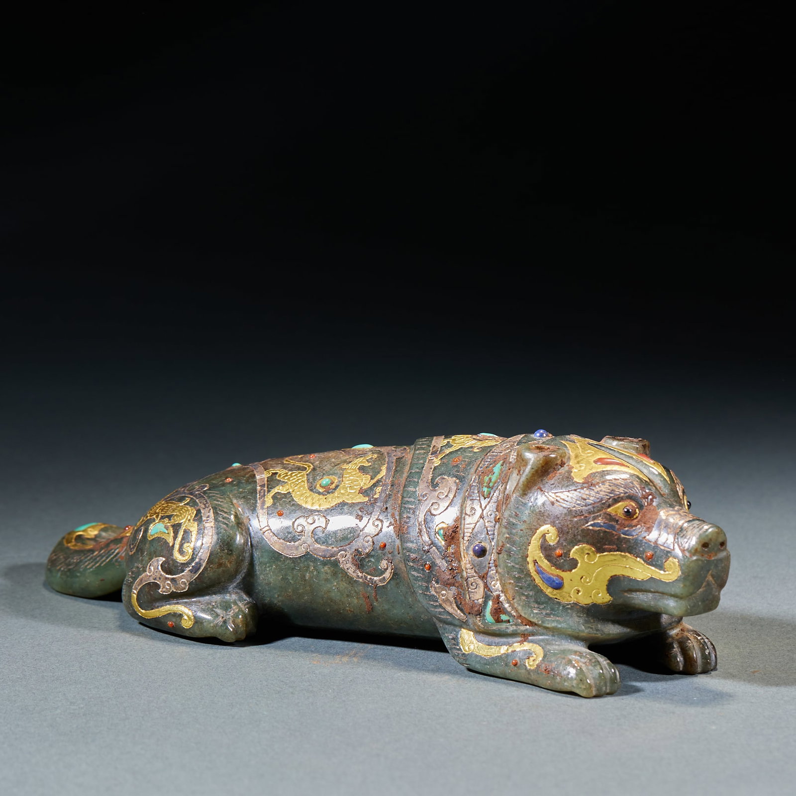 Gold Inlaid Jade Tiger Ornament: Gold-Inlaid Jade Tiger Ornament: Made of jade decorated with gold inlay and gemstone patterns, carved into powerful tiger shape; Height 5.5cm, length 21cm, width 7.5cm, weight 968g; A top-grade ancien