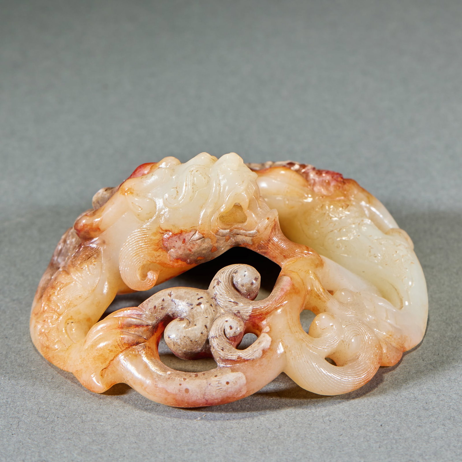 Han Dynasty Coiled Chilong Jade Pendant: Han Dynasty Coiled Chilong Jade Pendant: Made of jade with natural patina and mottling, high-relief carved with coiled chilong patterns featuring flexible lines and simple primitive coating; Height 4.