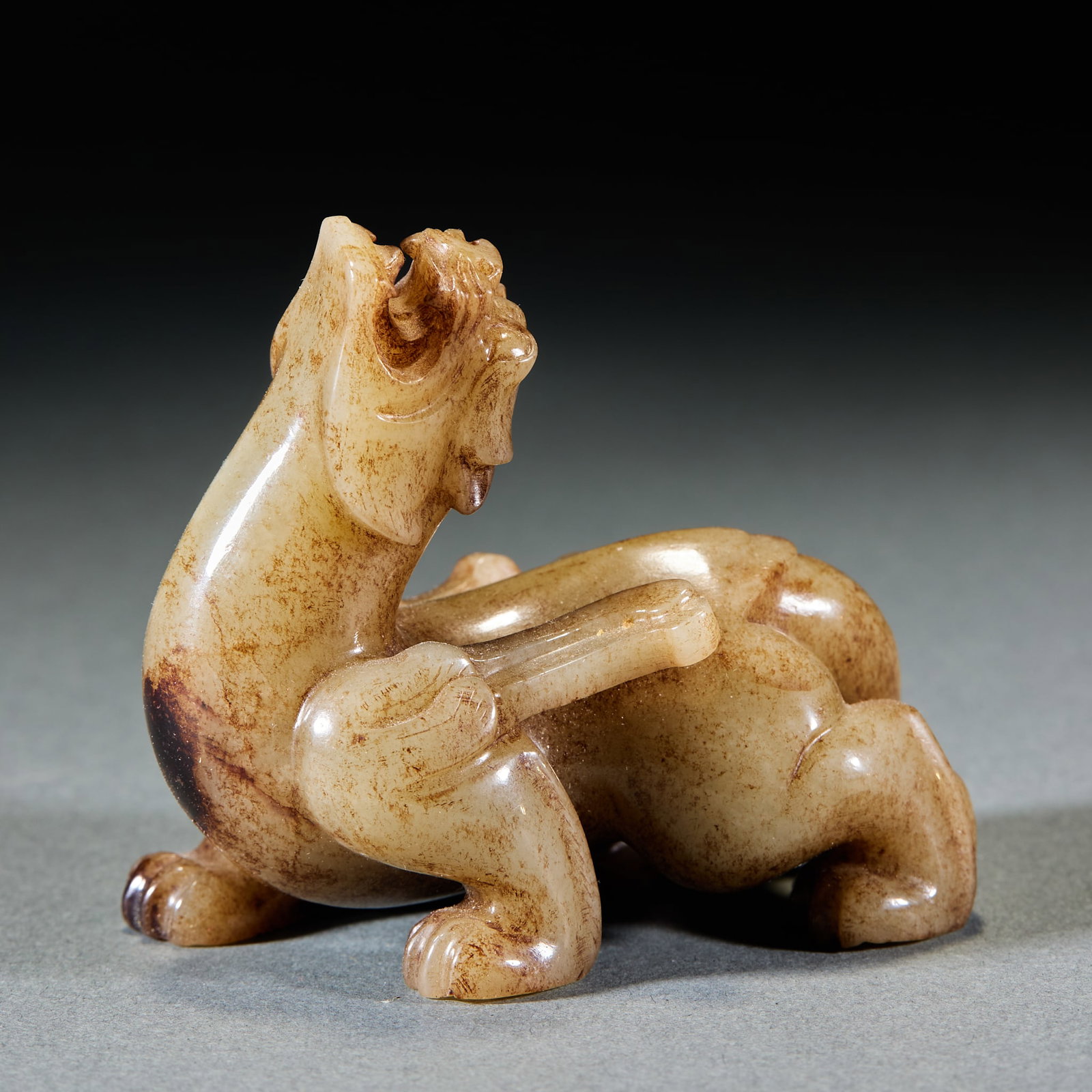 Han Dynasty Winged Auspicious Beast Jade Ornament: Han Dynasty Winged Mythical Beast Jade Ornament: Made of jade with natural mottling, round carved with powerful winged mythical beast shape; Height 6.5cm, length 7.8cm, width 4.3cm, weight 182g; Digni