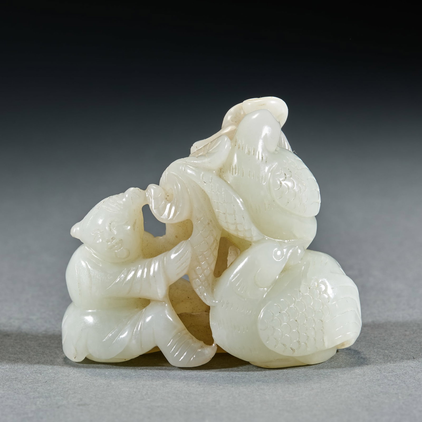 Qing Dynasty Hetian Jade Boy Playing with Goose Hand Piece: Qing Dynasty Hetian Jade Boy Playing with Goose Hand Piece: Made of white Hetian jade round carved with an innocent boy playing with goose implying auspiciousness; Height 6cm, length 6.5cm, width