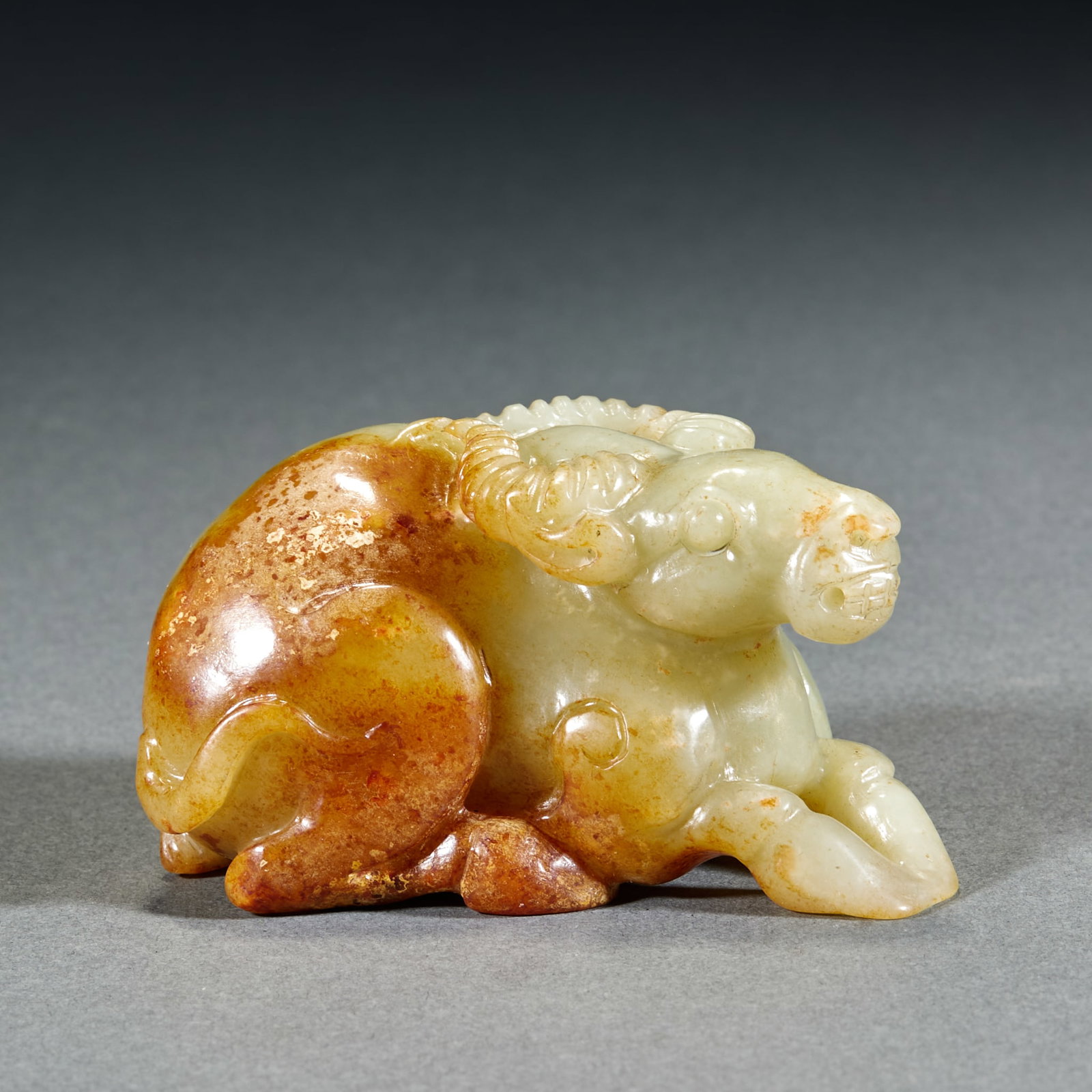 Qing Dynasty Hetian Jade Fortune Ox Ornament: Qing Dynasty Hetian Jade Auspicious Ox Ornament: Made of white Hetian jade with red mottling, round carved into reclining ox shape implying turning misfortune into good luck; Height 4.2cm, length