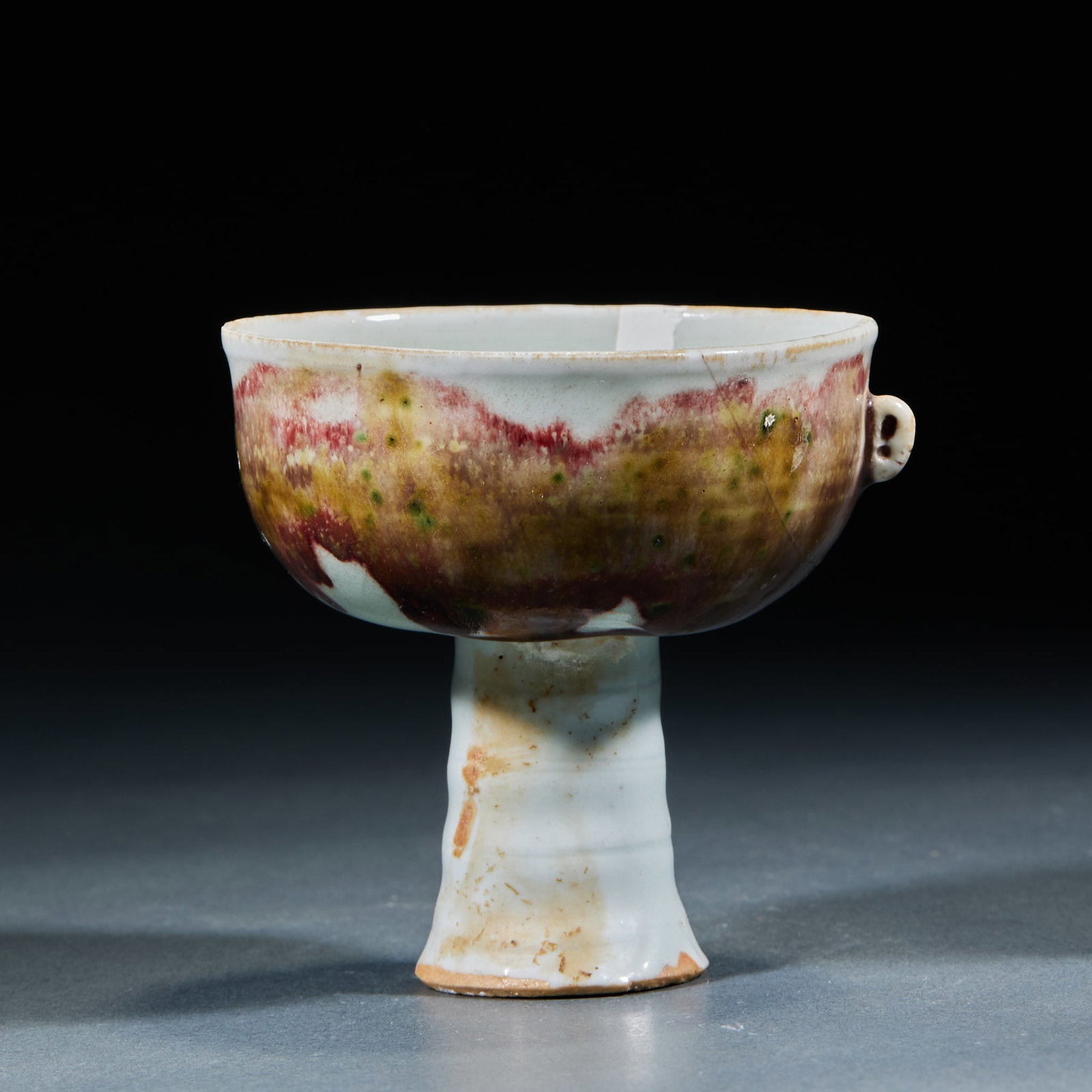 Jun Kiln High-Foot Cup: Jun Kiln Transmutation Glaze Stem Cup: Porcelain with natural transmutation glaze color and single loop handle; Height 8cm, diameter 8.5cm; Flowing natural glaze tone represents Song and Yuan Jun Kiln