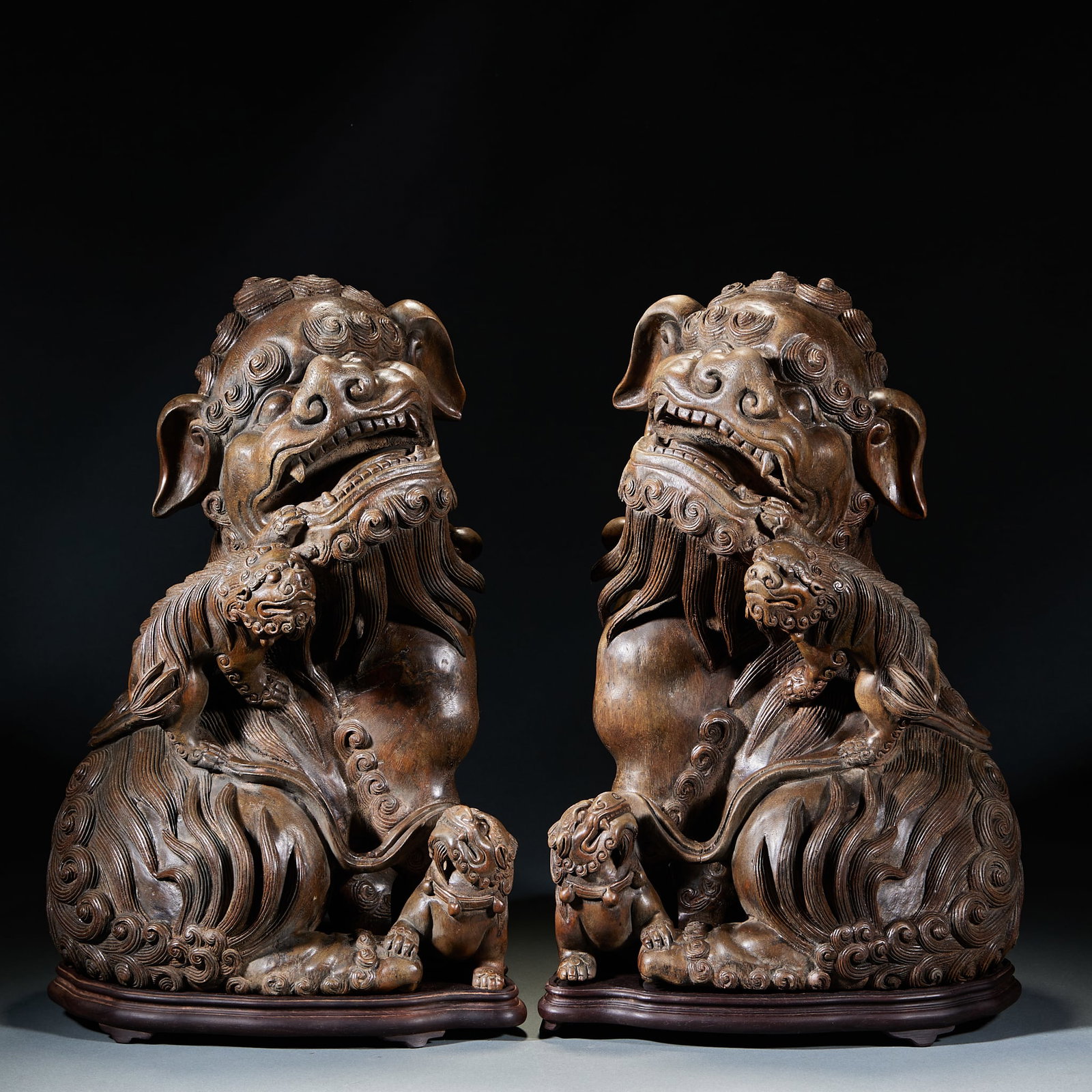 Agarwood Grand Tutor and Junior Tutor Ornament, A Pair: Pair of Agarwood Grand and Junior Lion Ornaments: Fully carved from natural agarwood as a matched pair, shaped into grand and junior lion form with fluent lines, primitive patina and steady fragrance;