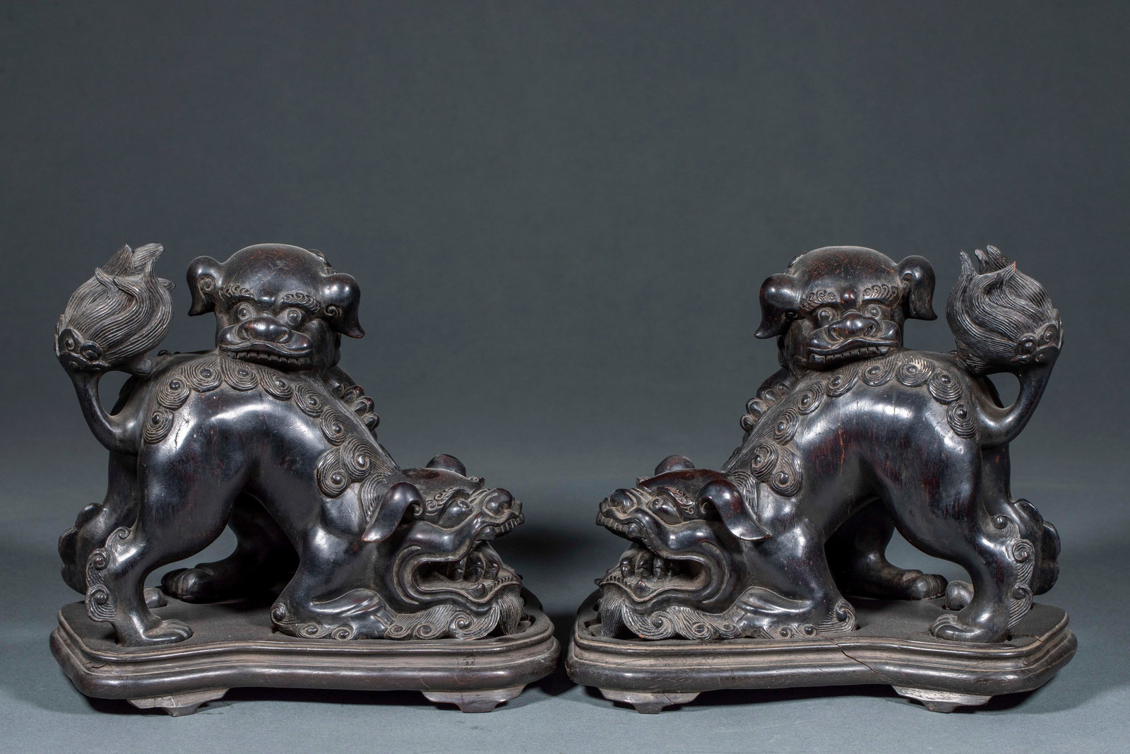 Red Sandalwood Grand Tutor and Junior Tutor Ornament, A Pair: Pair of Red Sandalwood Grand and Junior Lion Ornaments: Fully carved from natural large red sandalwood as a matched pair, shaped into grand and junior lion with delicate knife work, clear texture and