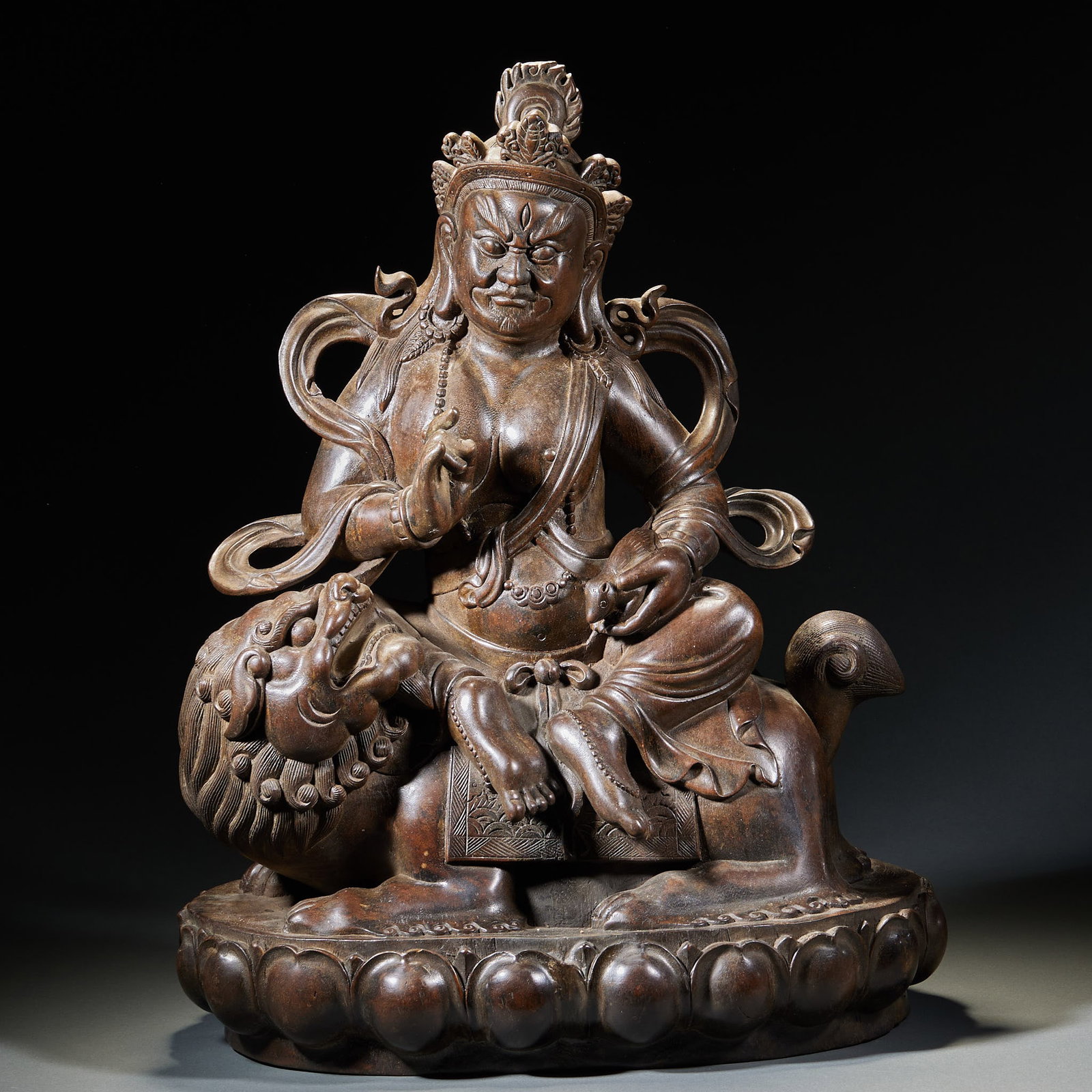 Agarwood Yellow Jambhala Statue: Agarwood Yellow God of Wealth Sitting Statue: Carved from agarwood into sitting Yellow God of Wealth riding lion on lotus throne; Height 49cm, length 39cm, width 20cm; Dignified image and primitive ca