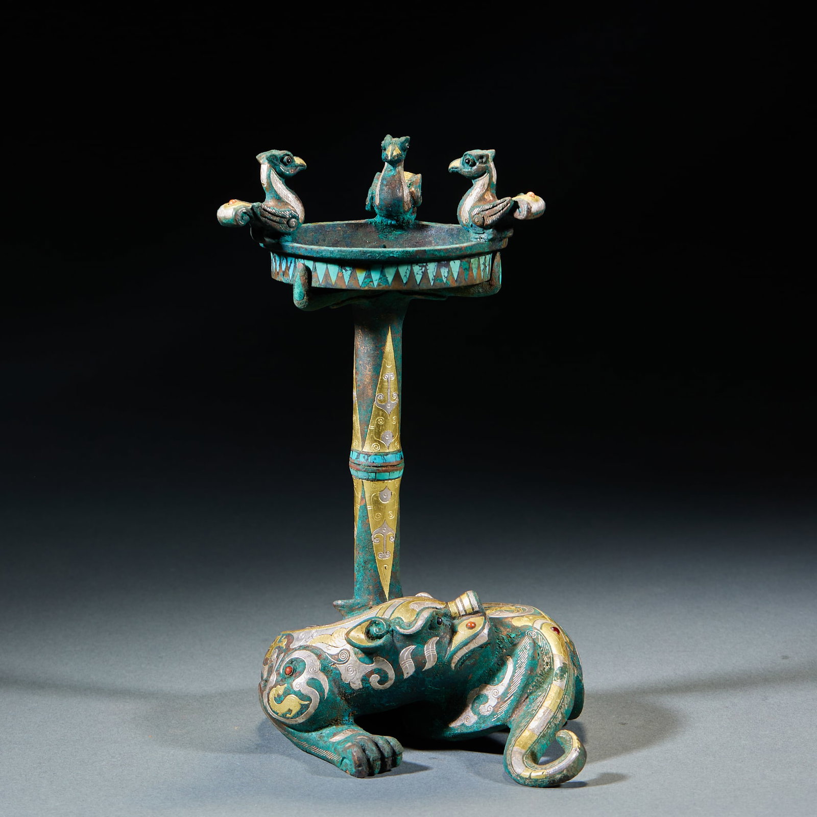 Gold and Silver Inlaid Auspicious Beast Candlestick: Gold and Silver Inlaid Mythical Beast Candlestick: Made of bronze decorated with gold and silver inlaid mythical beast patterns, regular shape and elaborate craft; Height 21cm, diameter 11.5cm; An anc