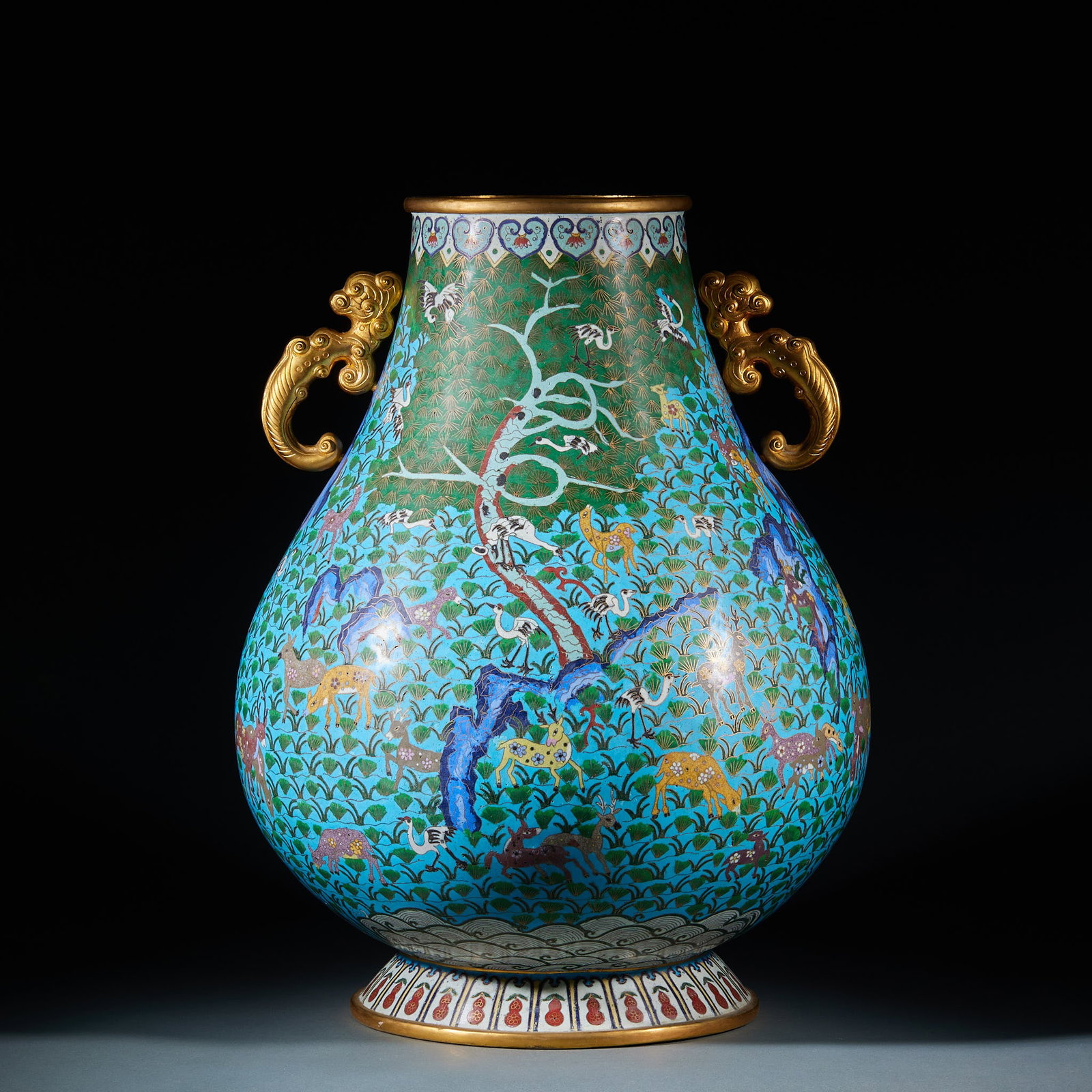 Enamel Pine and Crane Pattern Hundred Deer Zun Vase: Cloisonné Pine Crane and Hundred Deer Zun: Copper-bodied cloisonné with blue glaze background, wire inlaid and color filled with pine crane and hundred deer patterns, fitted with gilded double ears