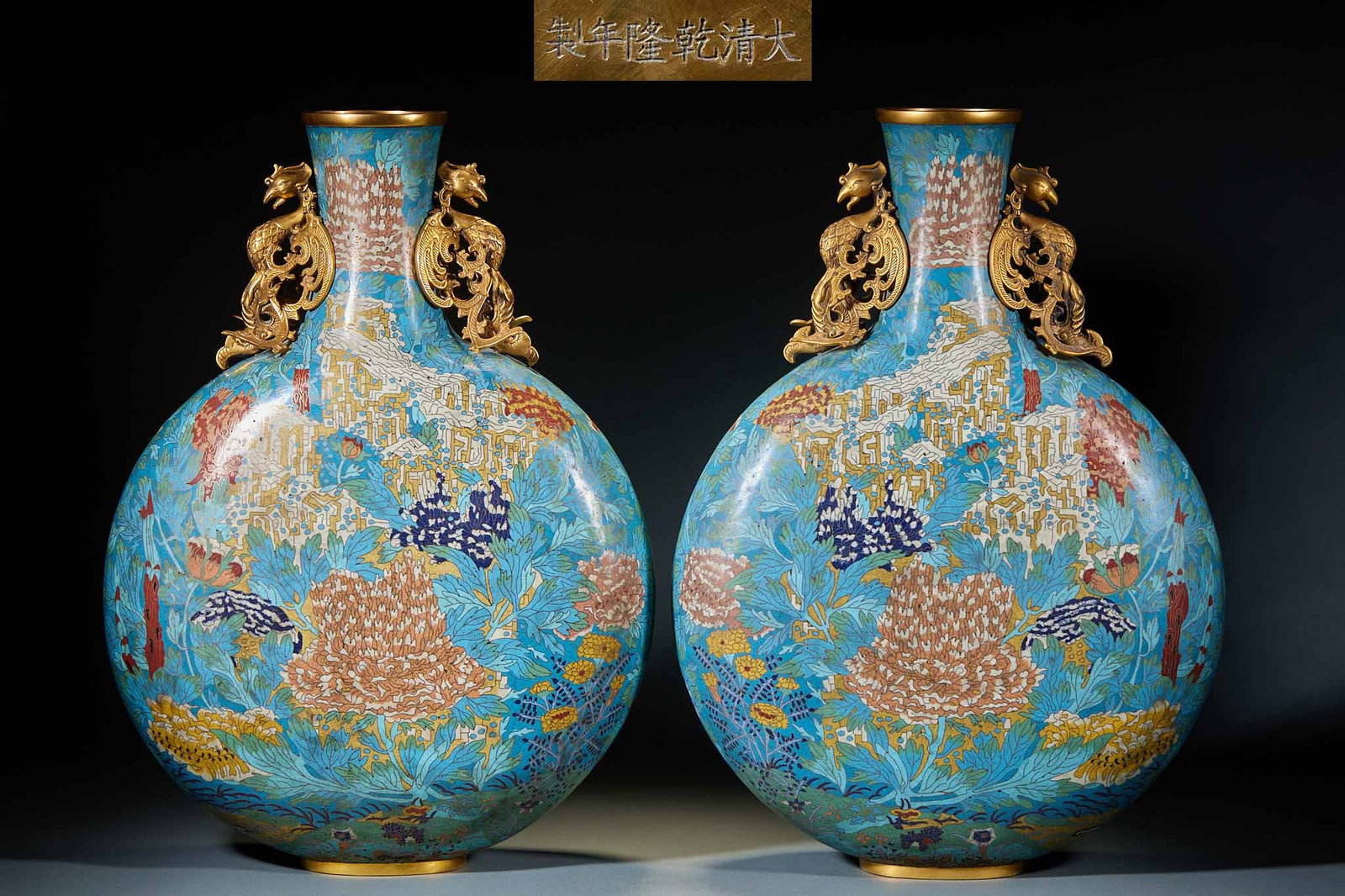 Qianlong Mark Enamel Flower Double Phoenix Ear Flat Vase, A Pair: Pair of Qianlong Mark Cloisonné Flower Double Phoenix Ear Flat Vases: Copper-bodied cloisonné made as a matched pair with blue glaze background, wire inlaid and color filled with flower patterns