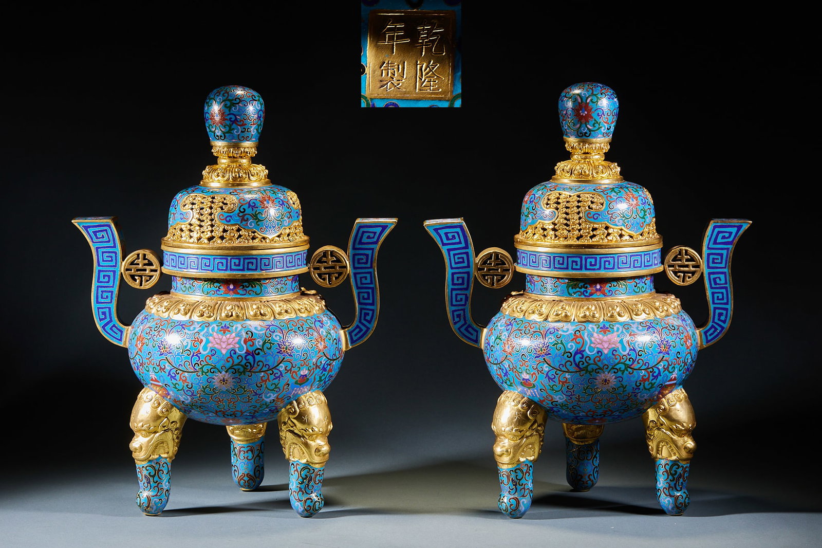Qianlong Mark Enamel Three-Foot Double-Eared Incense Burner, A Pair: Pair of Qianlong Mark Cloisonné Three-Foot Double-Ear Incense Burners: Copper-bodied cloisonné with blue glaze background, wire inlaid and color filled with interlocking flower patterns, openwork gi