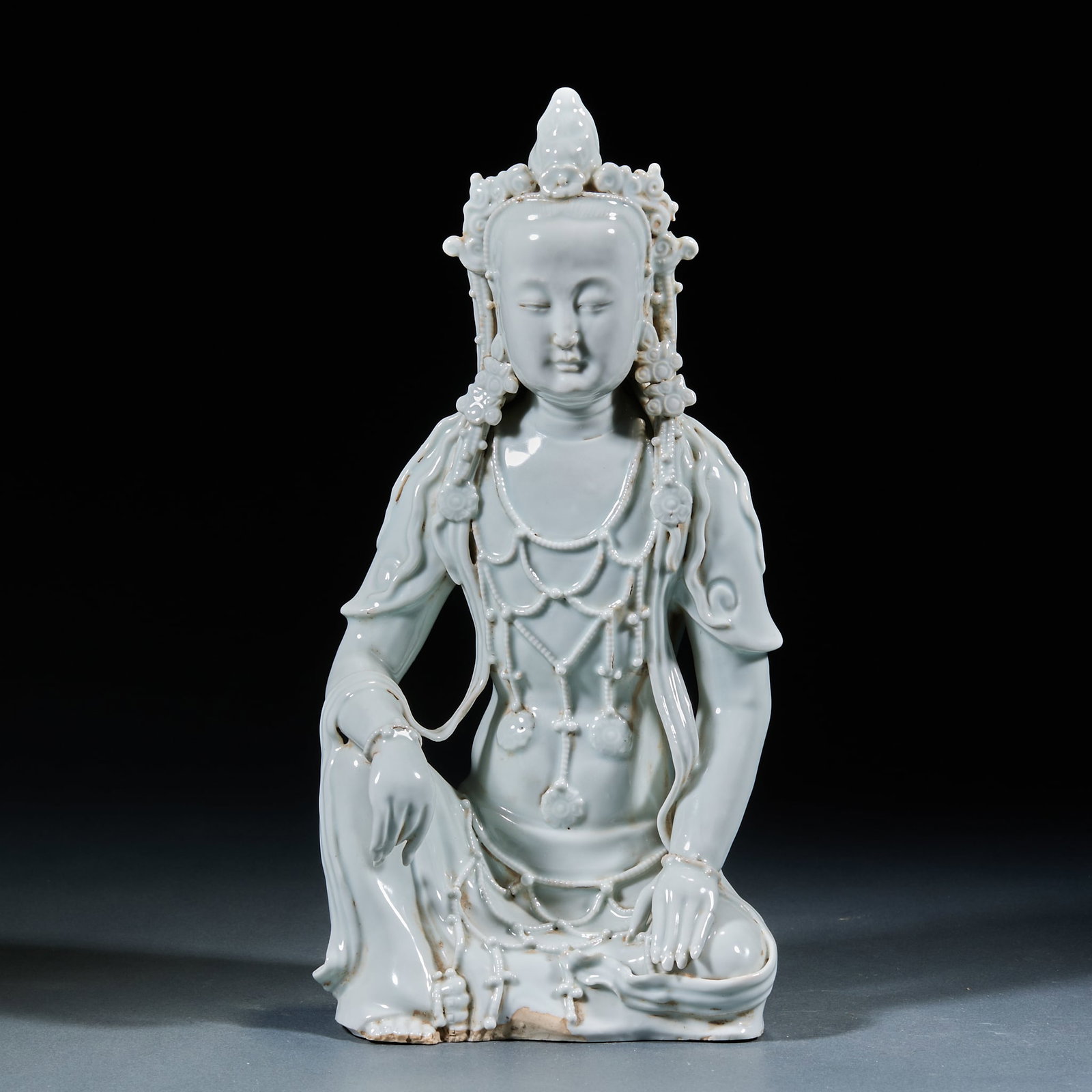 Hutian Kiln Shadow Green Glaze Guanyin Statue: Hutian Kiln Shadow Green Glaze Guanyin Statue: Porcelain with shadow green glaze molded with sitting Guanyin, solemn facial features, flowing robe lines and lustrous body and glaze; Height 29cm, lengt