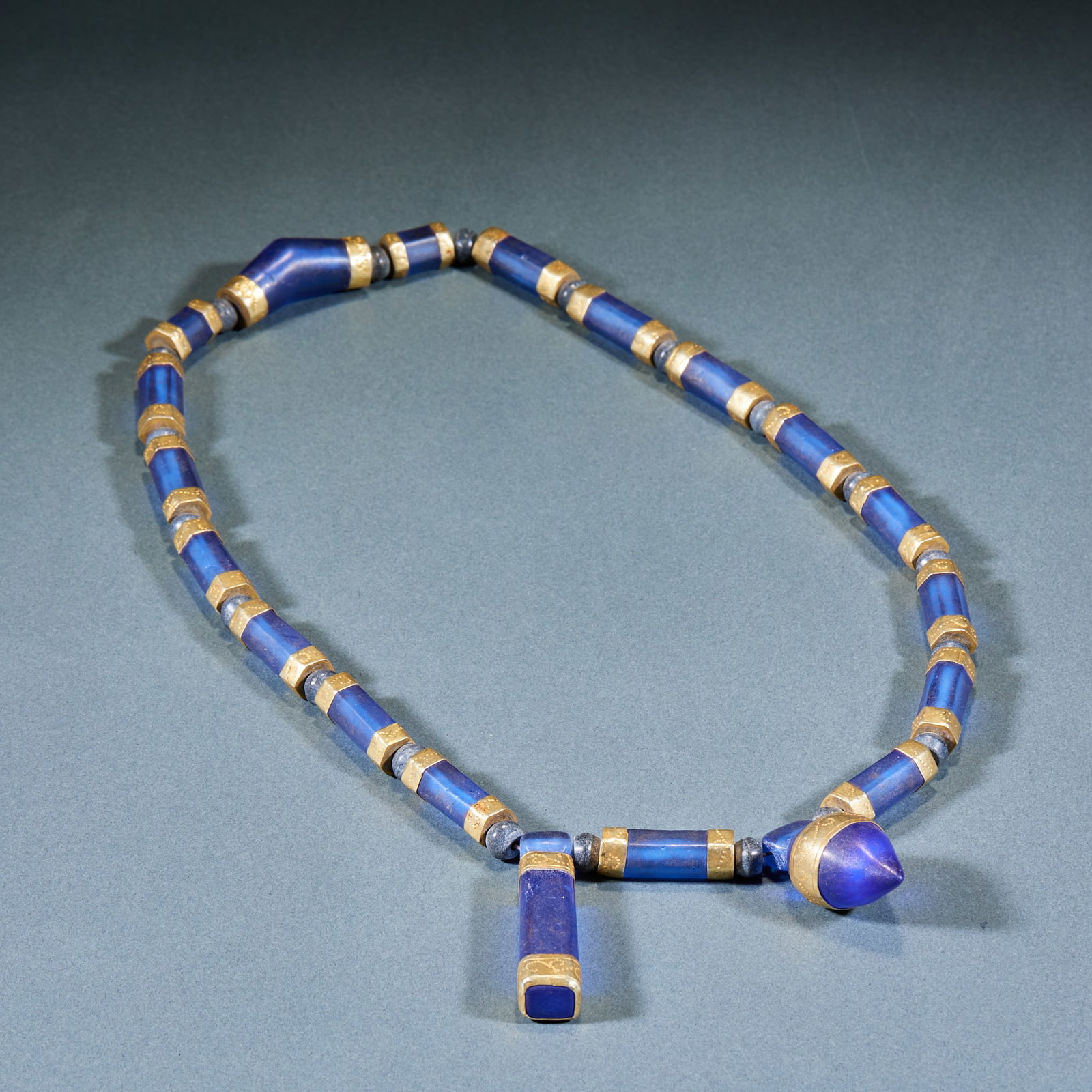 Gilt Colored Glaze Necklace: Gilt Glass Necklace: Made of sapphire-colored glass with gilt wrapped edge connection and regular shape; Length 31cm; Ancient noble jewelry with gorgeous color and exquisite craft.