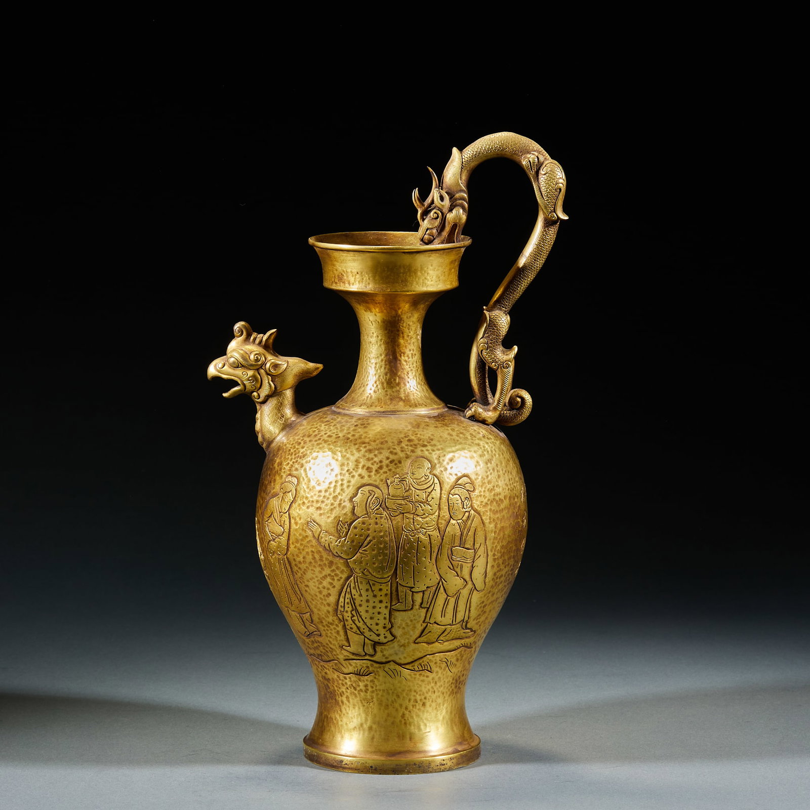 Gilt Bronze Dragon Phoenix Ewer Engraved with Hu People Presenting Treasures, Liao Dynasty: Liao Dynasty Gilt Bronze Dragon Phoenix Ewer Chiseled with Hu Men Presenting Treasures. The whole vessel fully gilded, spout molded as phoenix head, handle as coiled dragon, body layered chiseled