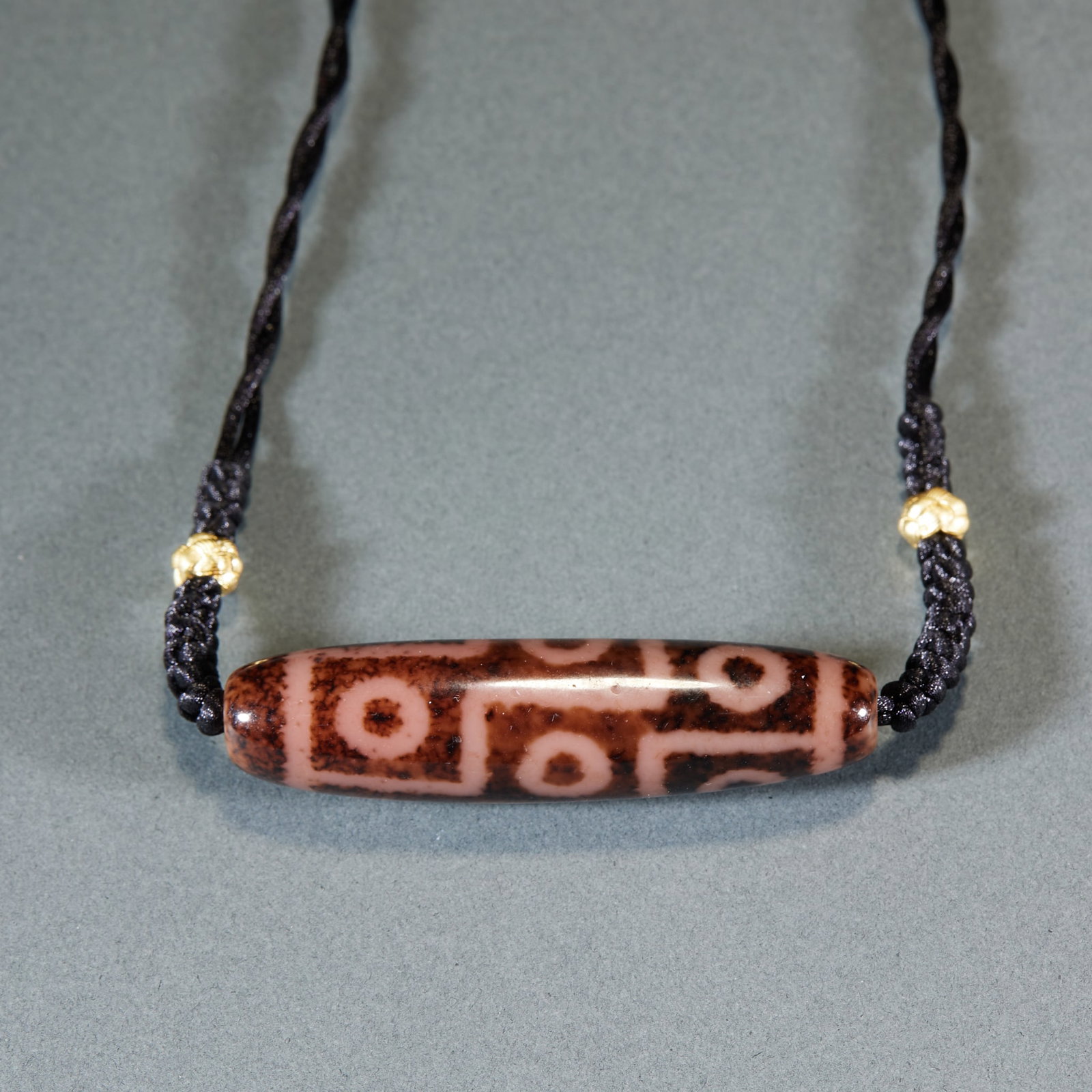 Nine-Eyed Dzi Bead: Nine-Eye Dzi Bead, made of natural etched agate substrate fired with traditional Tibetan etching craft into neat nine-eye totem, full mellow aged patina on bead body, matched with hand-woven black cor