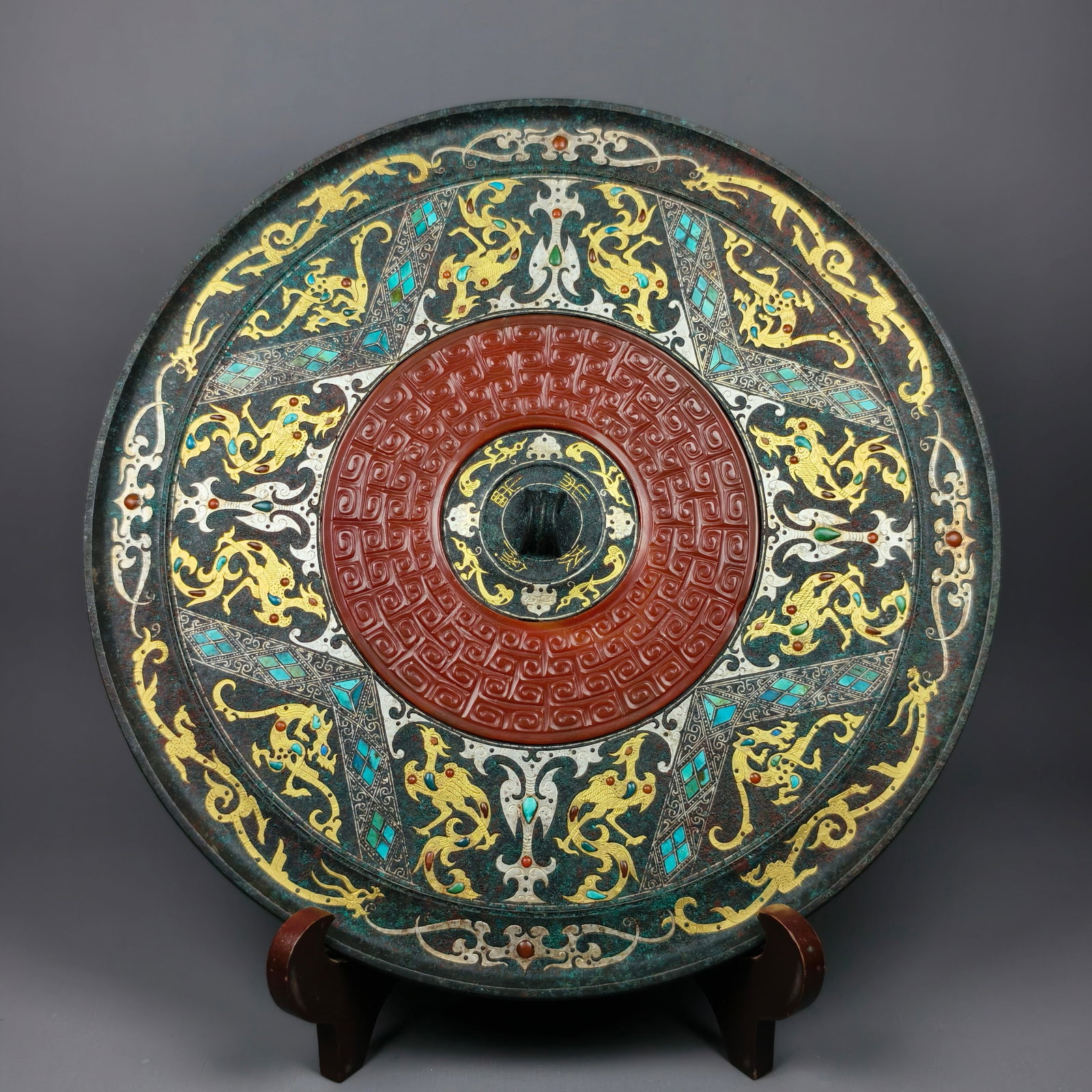 Han Dynasty Gold and Silver Inlaid Bronze Mirror with Jade Inlay: Han Bronze Round Mirror Gold-Silver Inlaid with Turquoise Carved with Dragon and Phoenix Patterns round mirror body diameter 26cm, dragon, phoenix and cloud qi patterns outlined via gold-silver inlay 