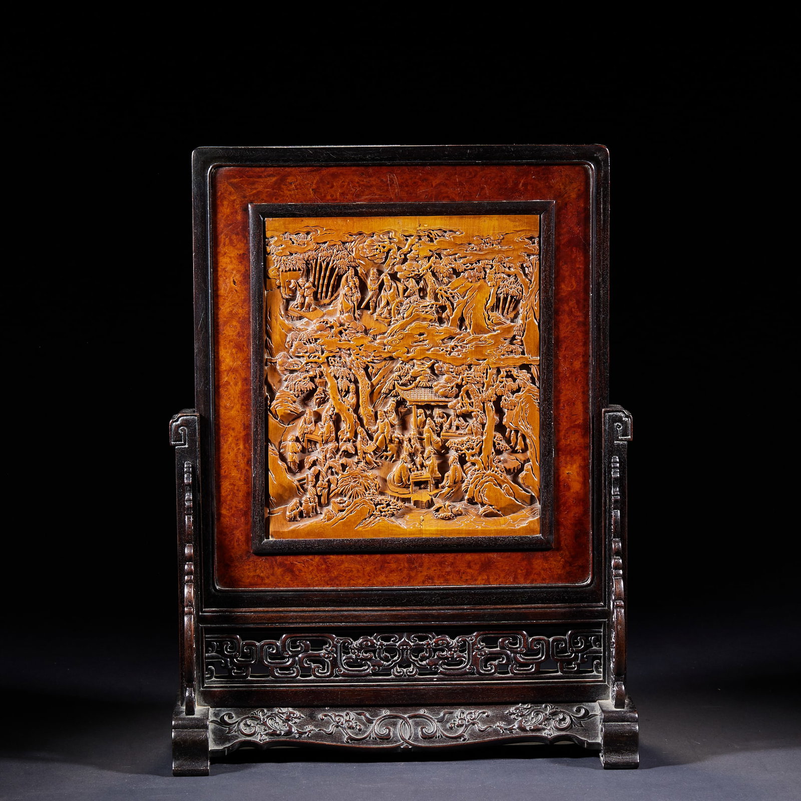 Red Sandalwood Table Screen Inlaid with Boxwood Narrative Figure Scenes: Zitan Wood Framed Table Screen with Boxwood High-Relief Figure Story, the outer frame and base carved from zitan wood, the base openwork carved with archaic scrolling grass patterns, the screen center