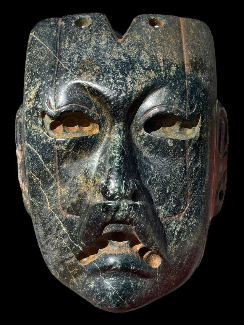Rare Pre-Columbian Olmec Were-jaguar serpentine mask: Rare Pre-Columbian Olmec Were-jaguar serpentine mask from Mexico, ca. 900-600 BCE. Carved from a dark serpentine stone with incised decoration. 7" height. x. Kevern Gregory, Fl. Ex. Luis Merida, Flori