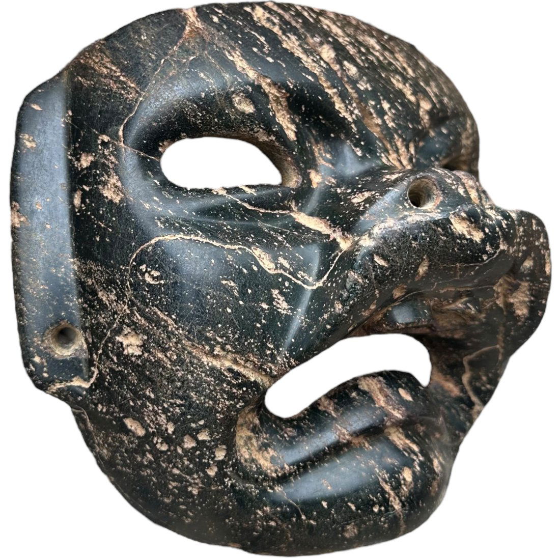 Pre-Columbian Olmec serpentine jaguar mask: Pre-Columbian Olmec stone jaguar mask from Mexico, ca. 900-600 BCE. Carved from a dark serpentine depicting a jaguar in transformation.6 3/4"x7 3/4"