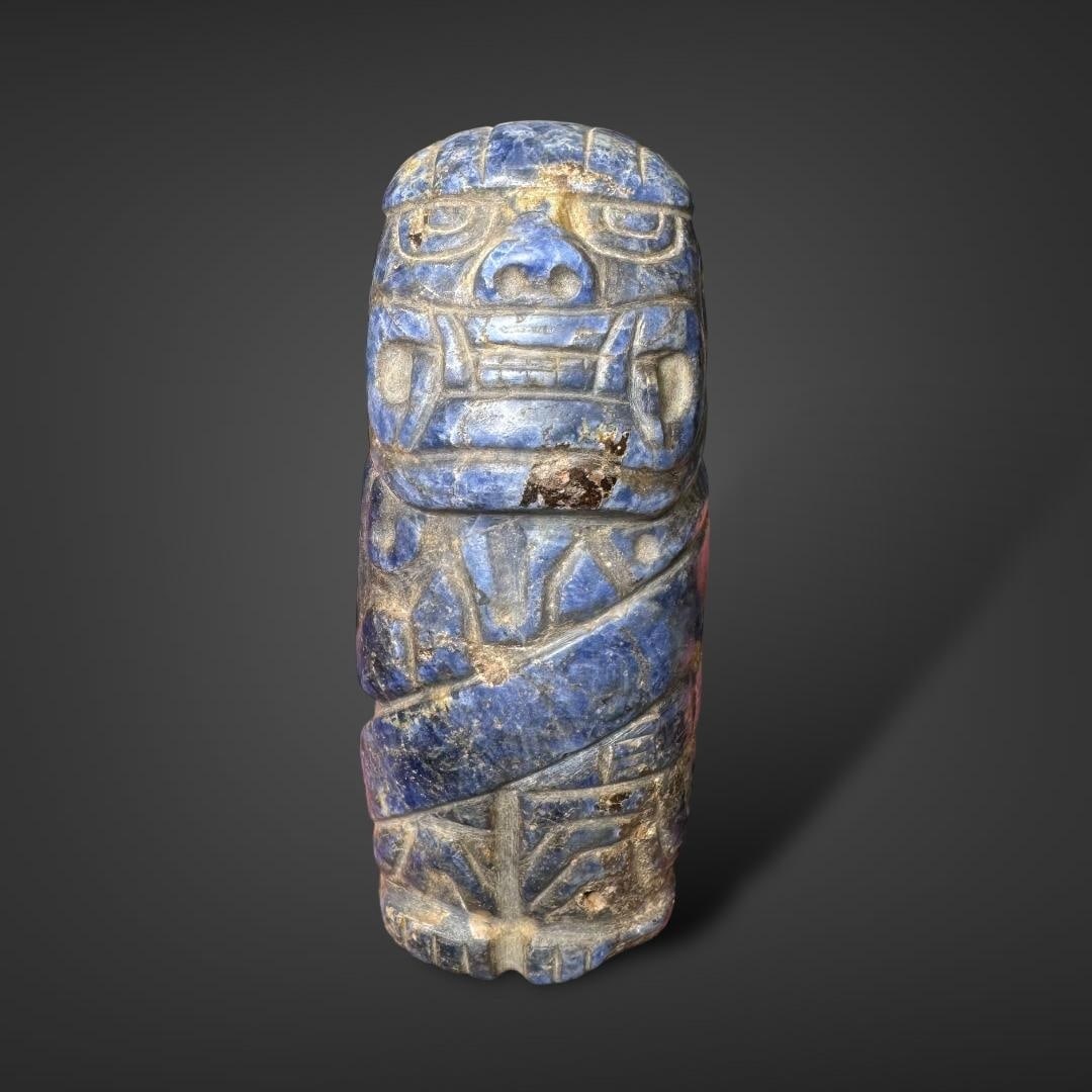 Pre-Columbian Chavin Lapiz Lazuli figure: Pre-Columbian Chavin figure, carved from lapis lazuli, is a remarkable artifact from the ancient Chavin culture of Peru (900–200 BCE). The figure exhibits bold craftsmanship, blending stylized human