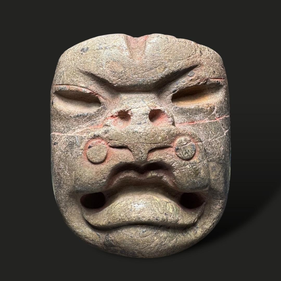 Pre-Columbian Olmec Green Stone Mask: Pre-Columbian Olmec Green Stone Mask: This intricately carved mask, originating from the Olmec civilization (circa 1200–400 BCE), is crafted from green stone, a material highly valued for its symbol