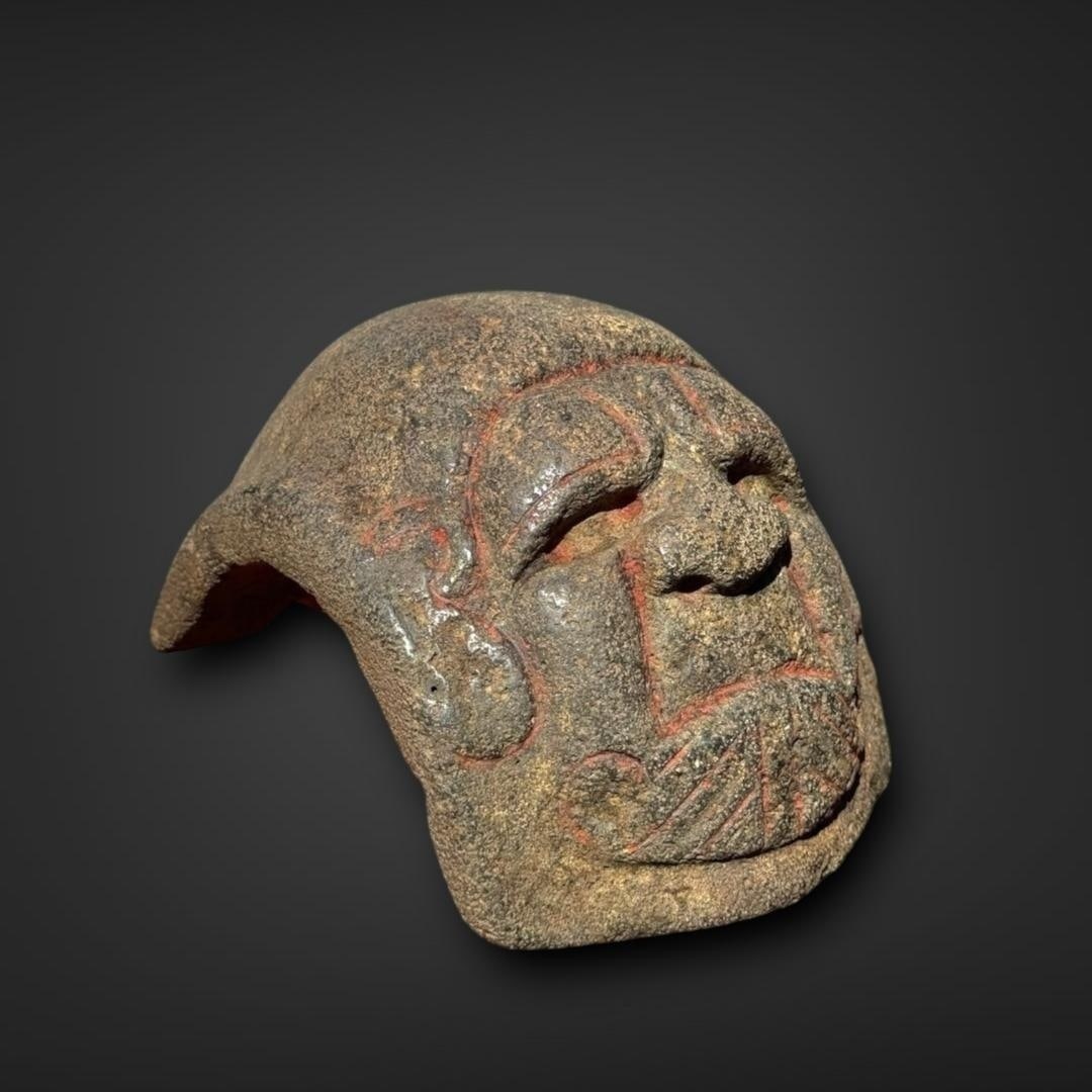 Rare Pre-Columbian Olmec stone yuguito: Mexico, circa 900-600 BC. Olmec stone yuguito, a small ceremonial object associated with the Mesoamerican ballgame. The piece is carved from a rough, dark stone, likely basalt or a similar material, a