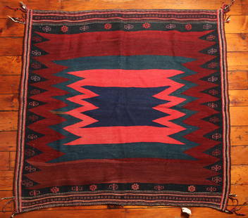 Turkish Sofreh Kilim Rug: Type: Rug Materials: Dyed wool Markings & Inscriptions: Unmarked Date: Early to mid 20th century Maker: Turkish Description: A Sofreh Kilim rug with geometric decoration and corner fringe or tassels.