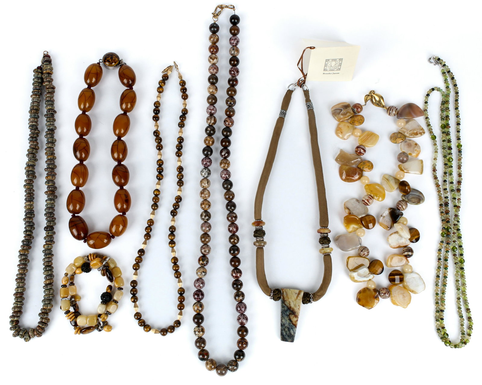 Seven Necklaces & a Bracelet, Including Tiger's Eye, Jade, Semi-Precious Stones and Silver: Type: Necklace, bracelet Materials: Tiger's eye, jade, semi-precious stones, silk, silver Markings & Inscriptions: One neckace marked Sojourner, one marked silver Date: Late 20th century / contemporar