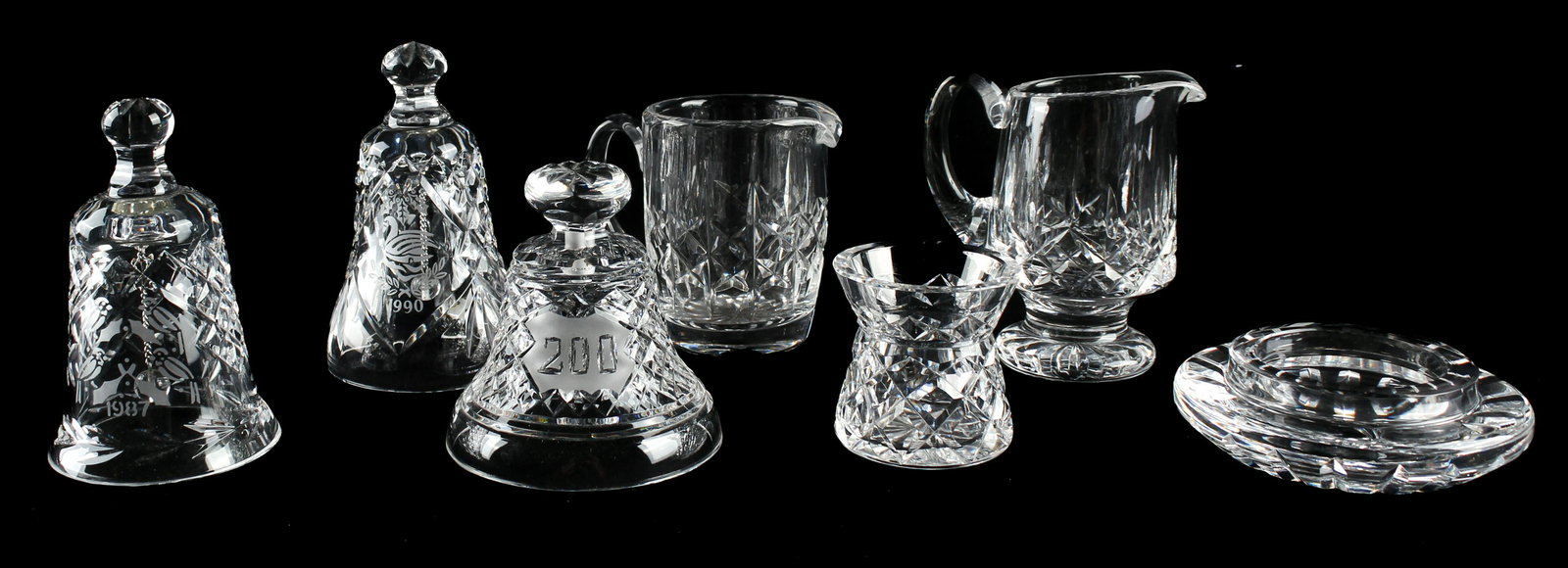 A Group of Seven Waterford Crystal Items: Type: Bells, Creamers, Votive, Toothpick holder Materials: Crystal, Glass Markings & Inscriptions: Marked Date: Late 20th century Maker: Waterford Description: Eight Waterford crystal articles to incl