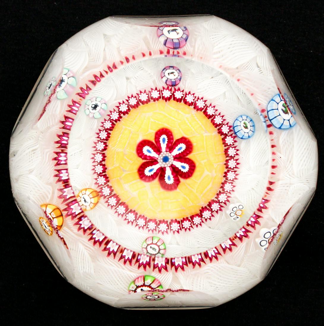 Perthshire Glass Paperweight: Type: Paperweight Materials: Glass Markings & Inscriptions: Marked and labeled Date: 2000 Maker: Perthshire Paperweights Description: A faceted paperweight with a central millefiori flower design surr