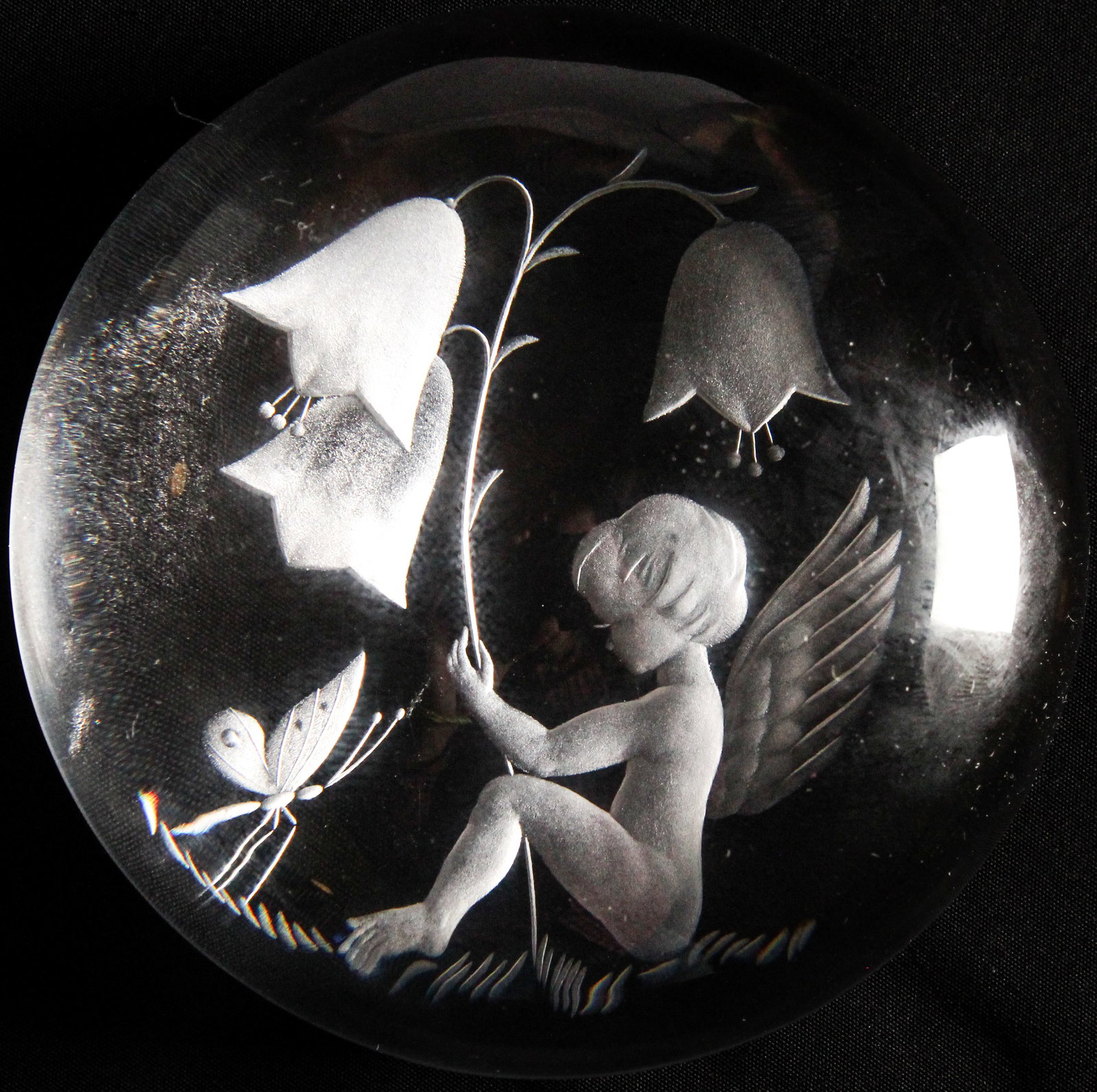 Max Erlacher Art Glass Paperweight: Description: A Max Erlacher art glass paperweight depicting a winged cherub, butterfly, and bellflowers. Type: Paperweight Materials: Glass Markings & Inscriptions: Initialed "MRE" and dated Date: 197