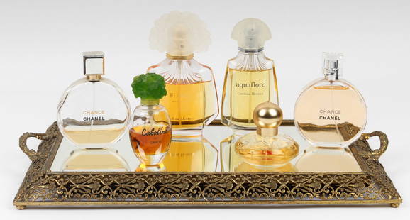 Six Bottles of Designer Perfume and Eau de Toilette with Vintage Mirrored Dresser Tray: Description: A vintage mirrored dresser tray and six bottles of designer perfume or eau de toilette, consisting of Carolina Herrera Flore perfume (3.4 oz.), Chanel Chance perfume (3.4 oz.), Cabotine d