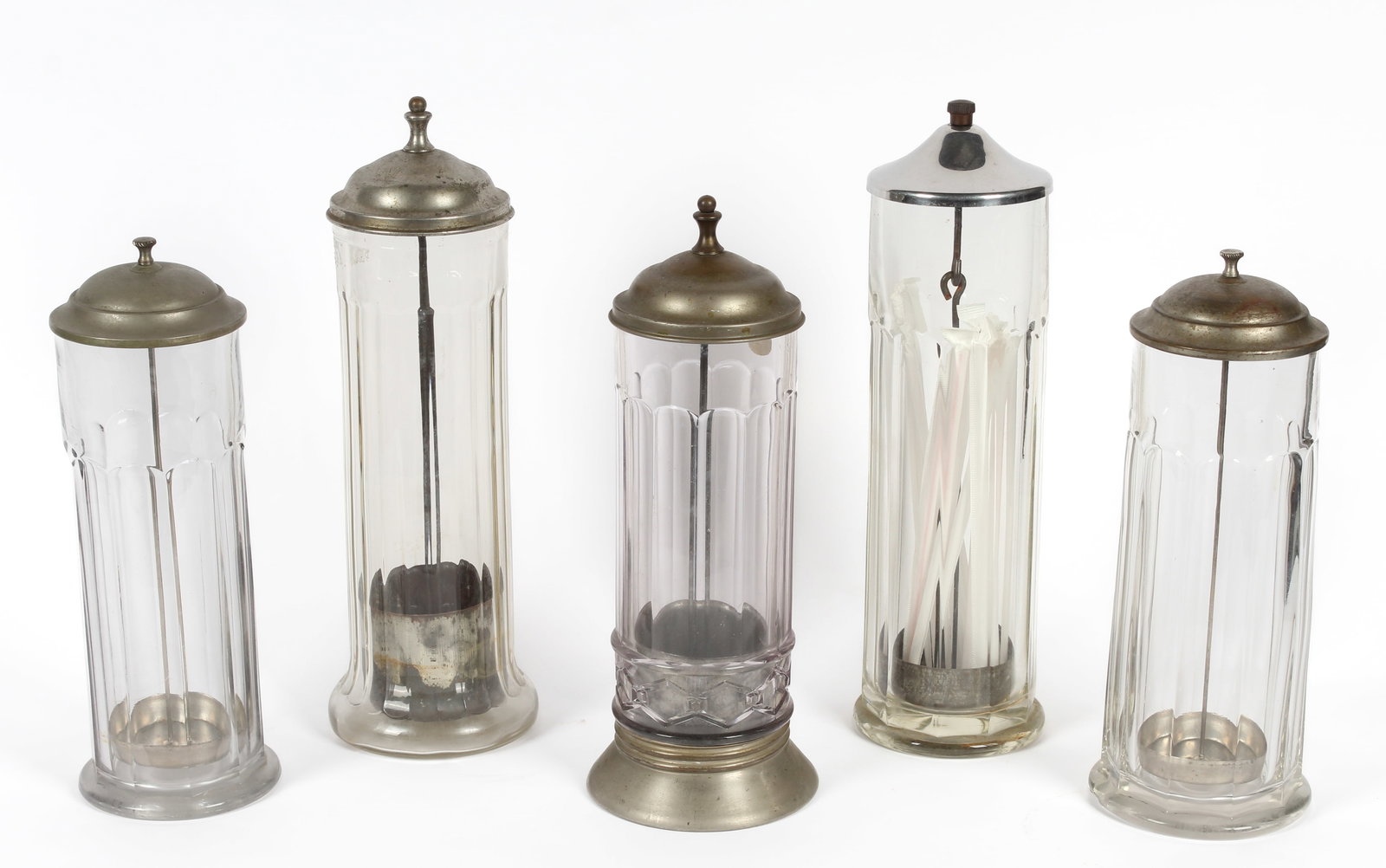 Five Soda Fountain Countertop Glass Straw Holders, incl. Benedict: Description: A collection of five vintage soda fountain lidded glass straw holders. One stamped for "Benedict".Type: Straw holderMaterials: Glass, metalMarkings & Inscriptions: One marked "Benedict"Da