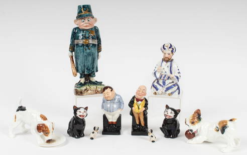 English Porcelain Figurines Incl. Majolica Palmer Cox Brownie, Royal Doulton, Etc.: Description: A group of vintage English porcelain figurines including examples by Royal Doulton and a majolica Palmer Cox Brownie figure.Type: Figurine Materials: PorcelainMarkings & Inscriptions: Mar